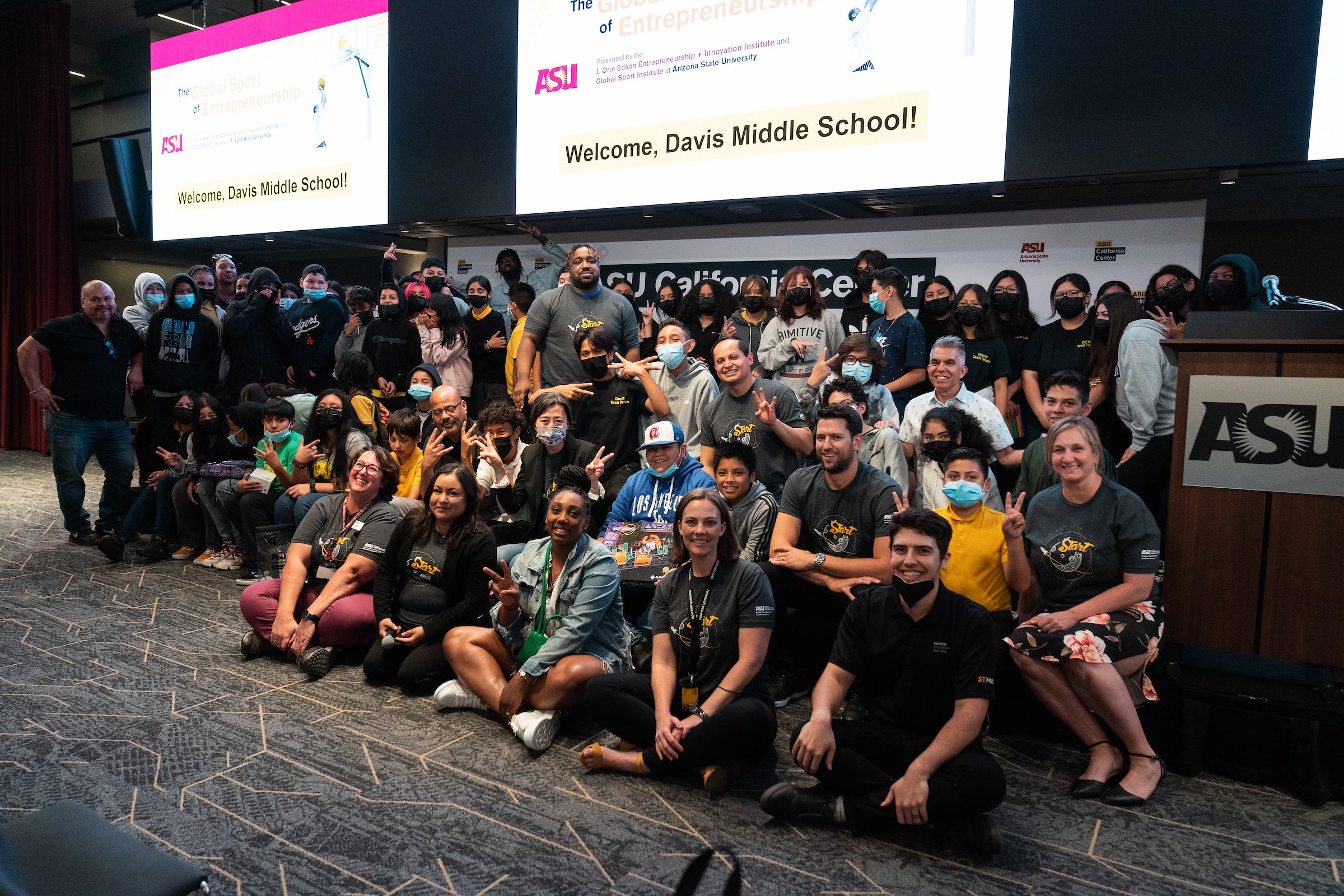 A group of 100 Davis Middle School students and ASU staff on stage together at the ASU California Center.