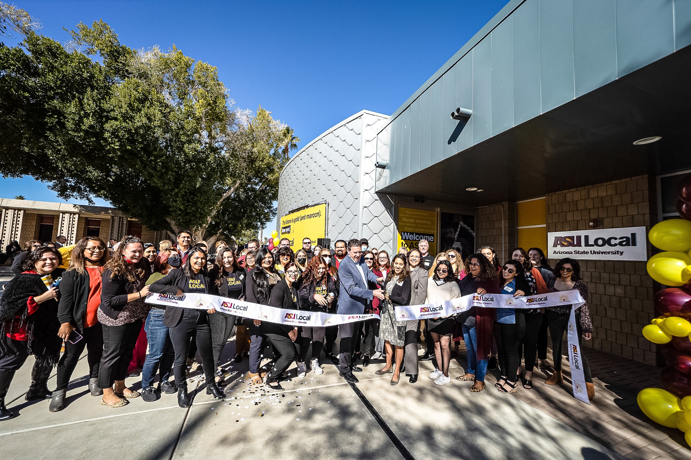 group of people gathered for ribbon cutting ceremony