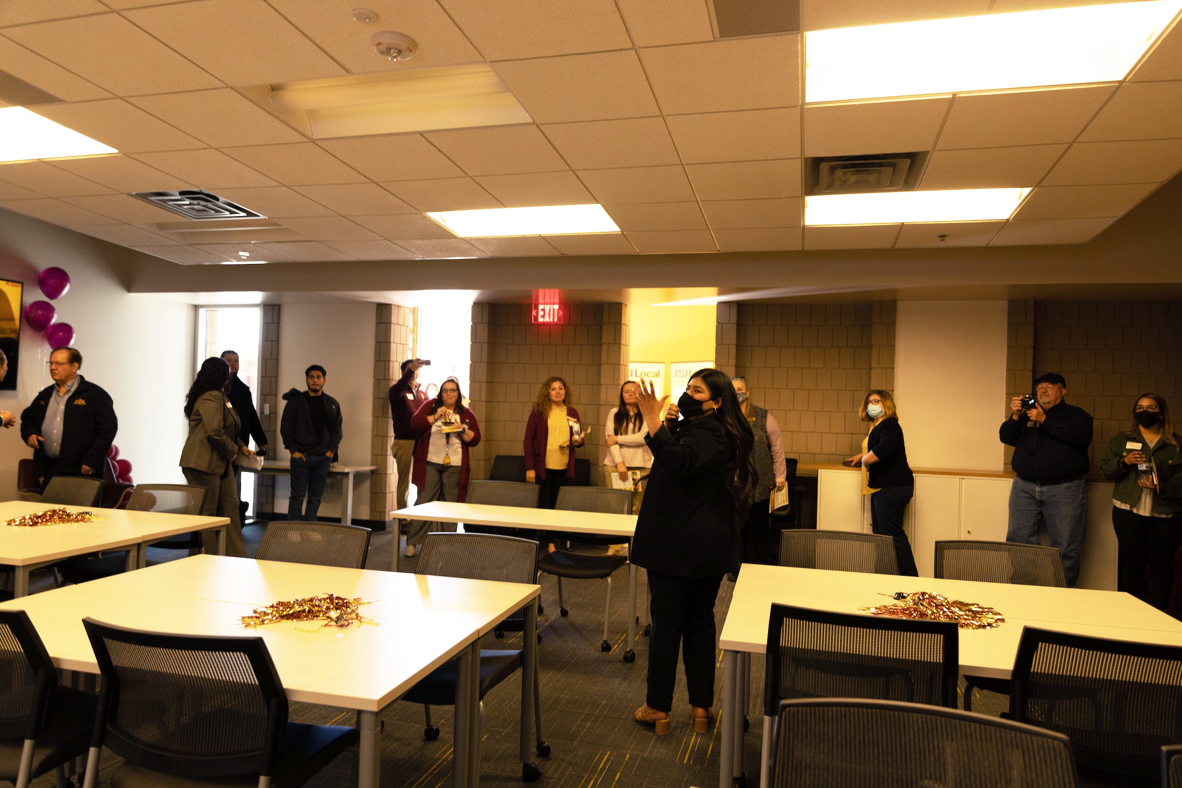 woman giving a tour of a classroom to community members