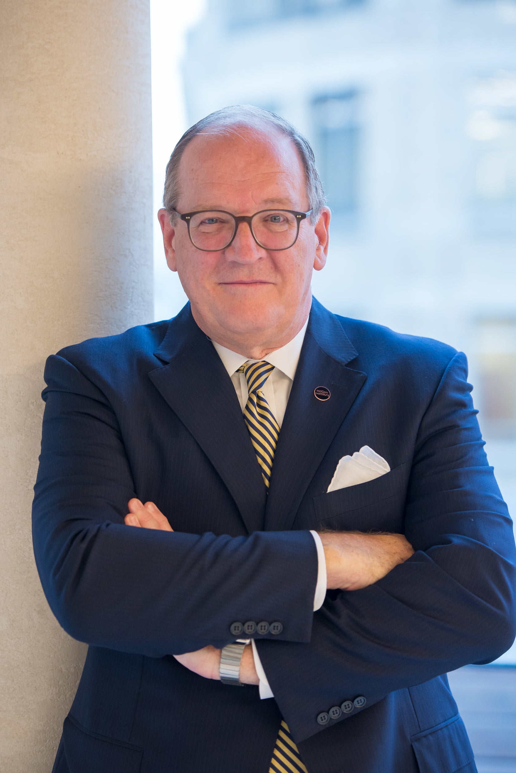 Man in glasses with arms crossed