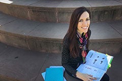 woman sitting on steps with books