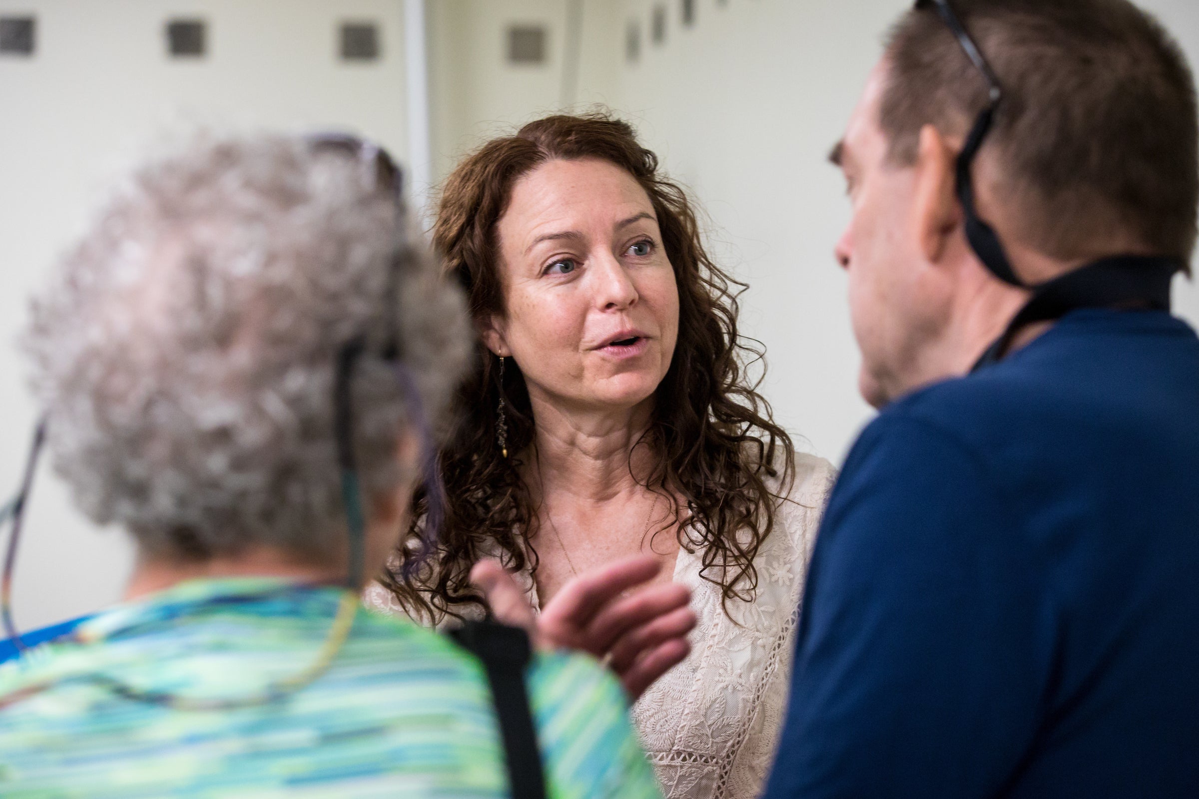 woman speaking to two people