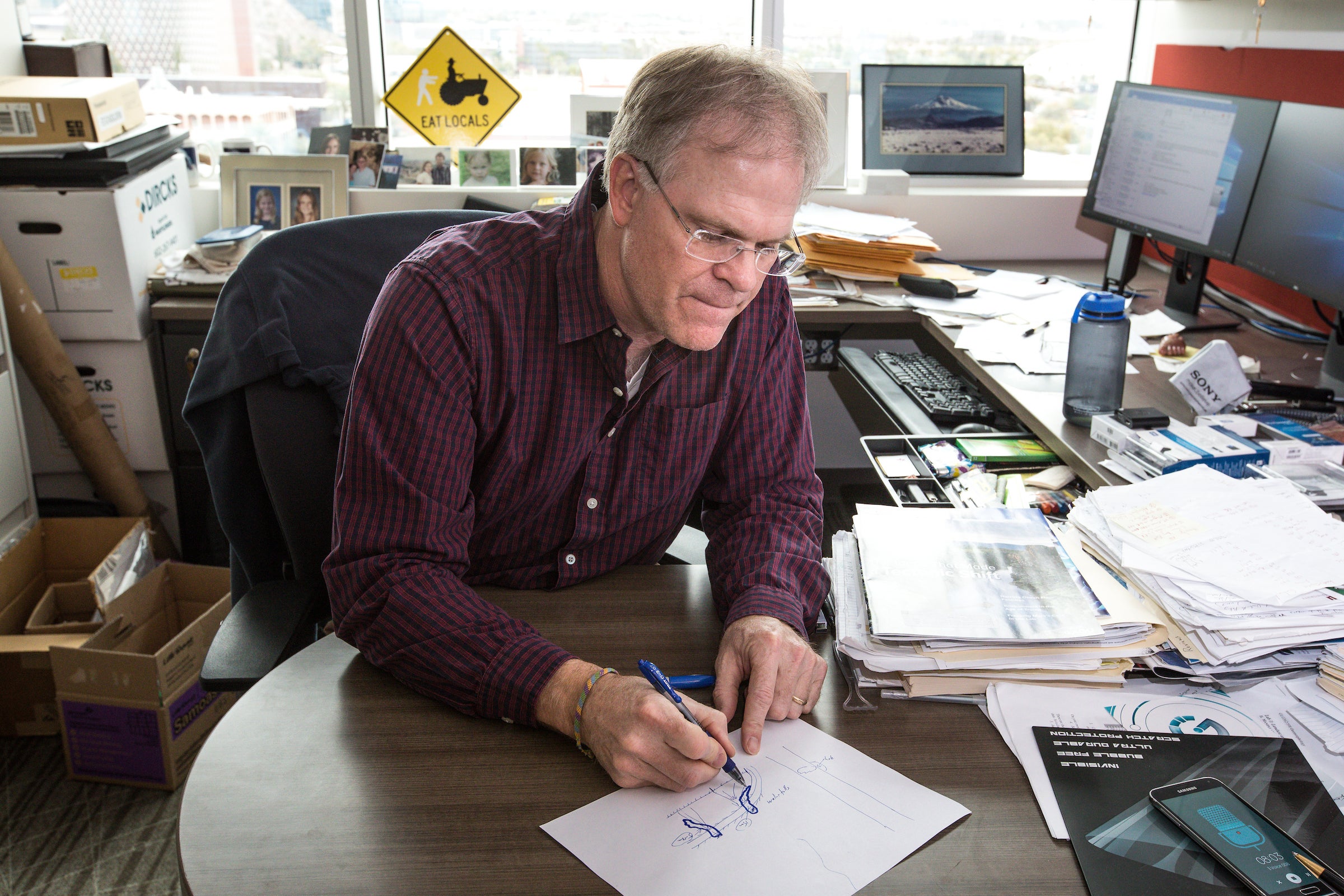 man diagramming on piece of paper