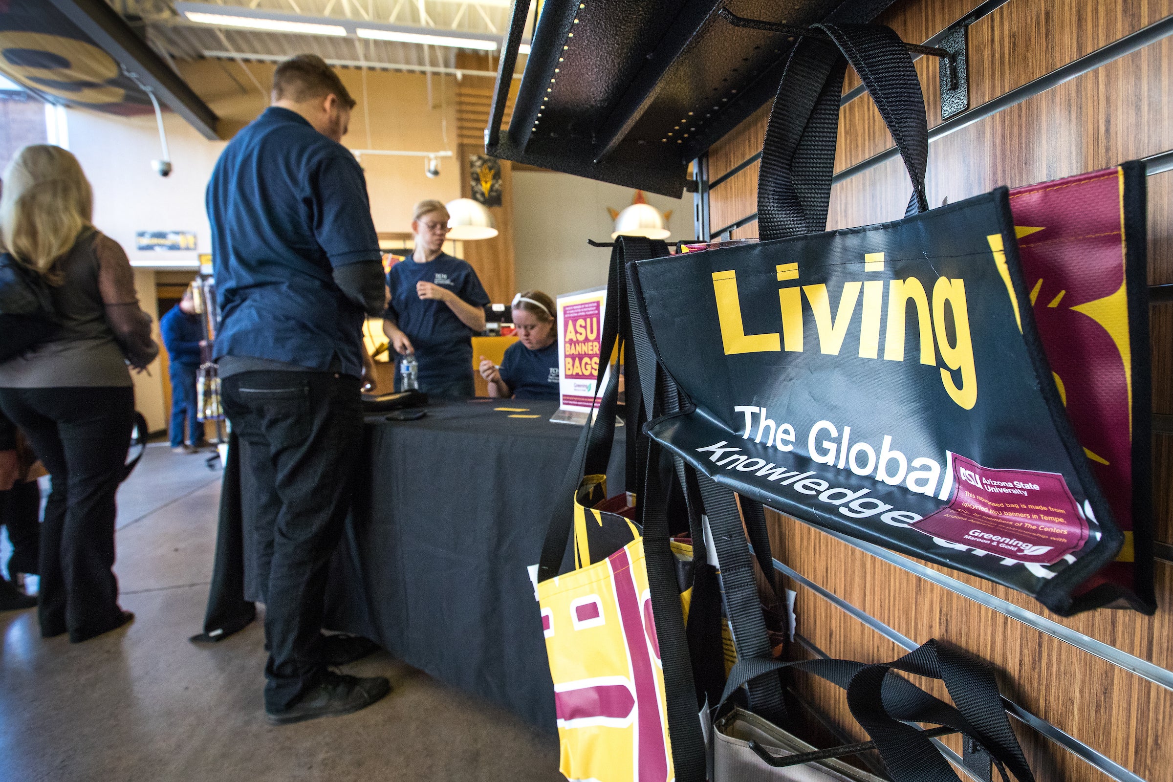 bags made of old banners on display at bookstore