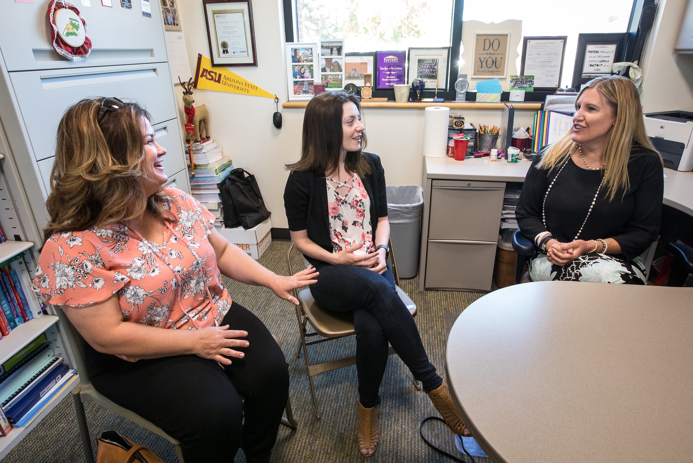 three women sitting in an office