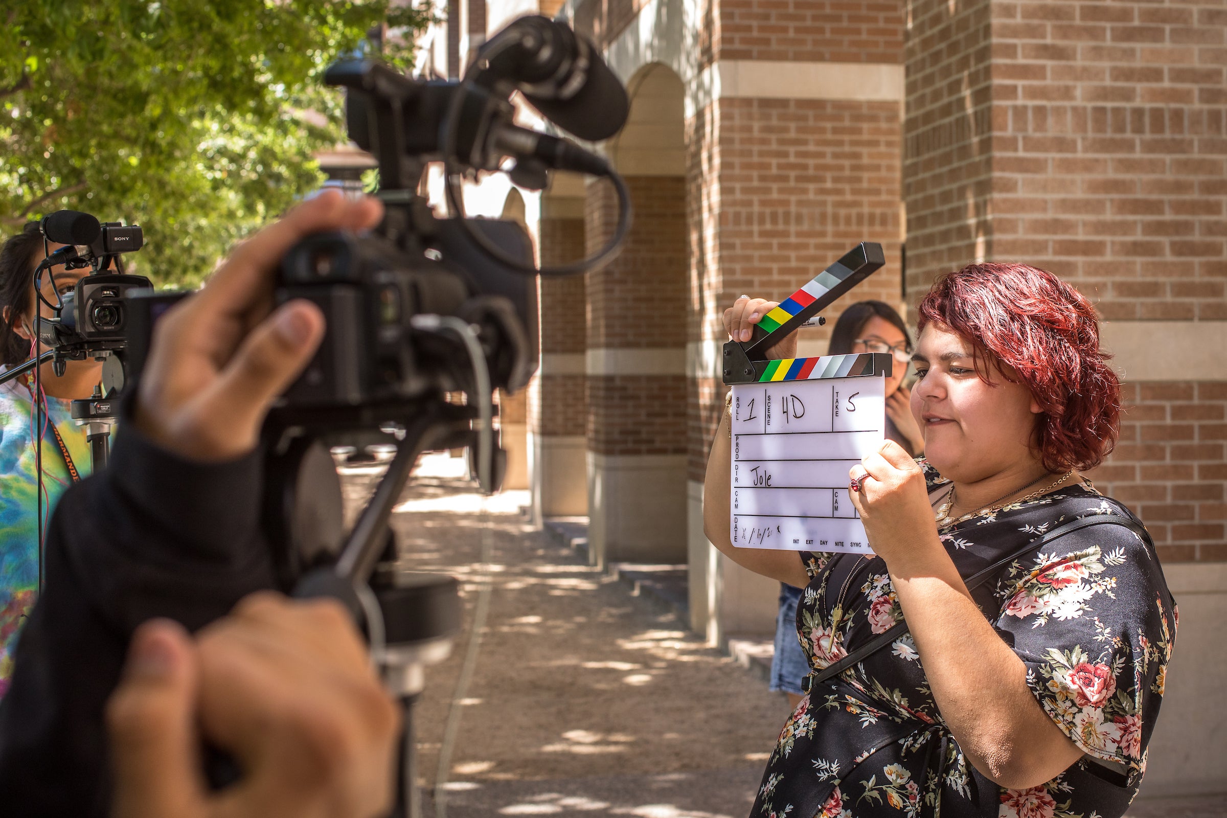 woman holds a movie clapper