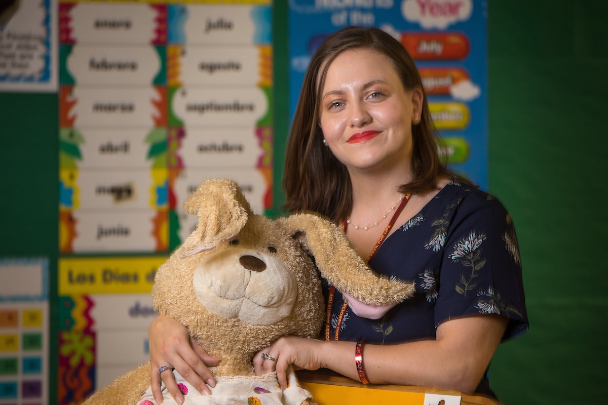 Woman holding stuffed teddy bear