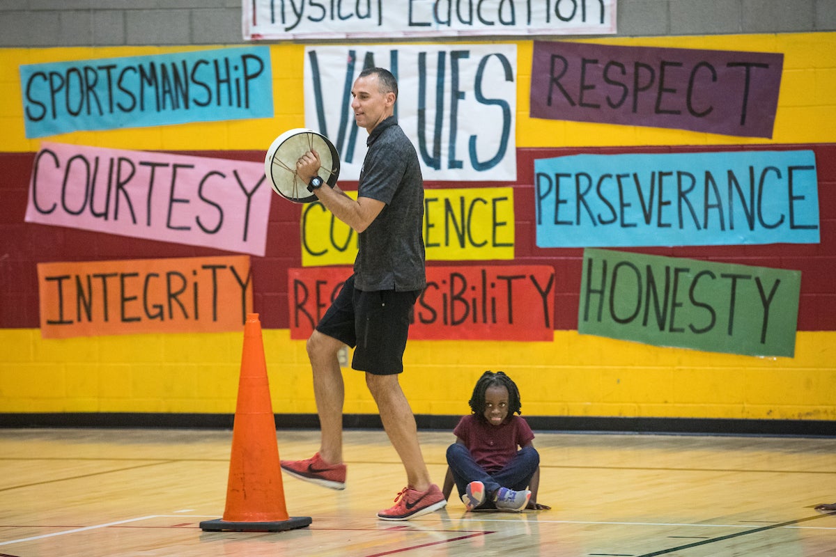 Man in gym with student