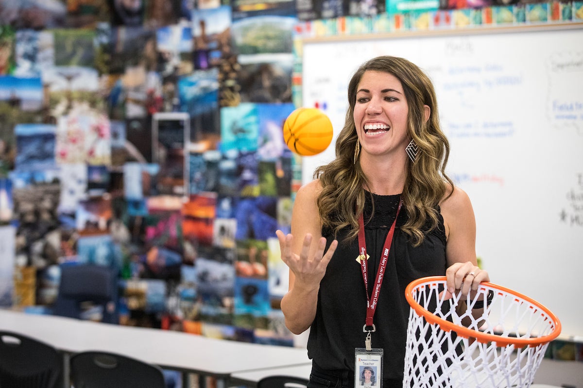 Woman holding miniature basketball 