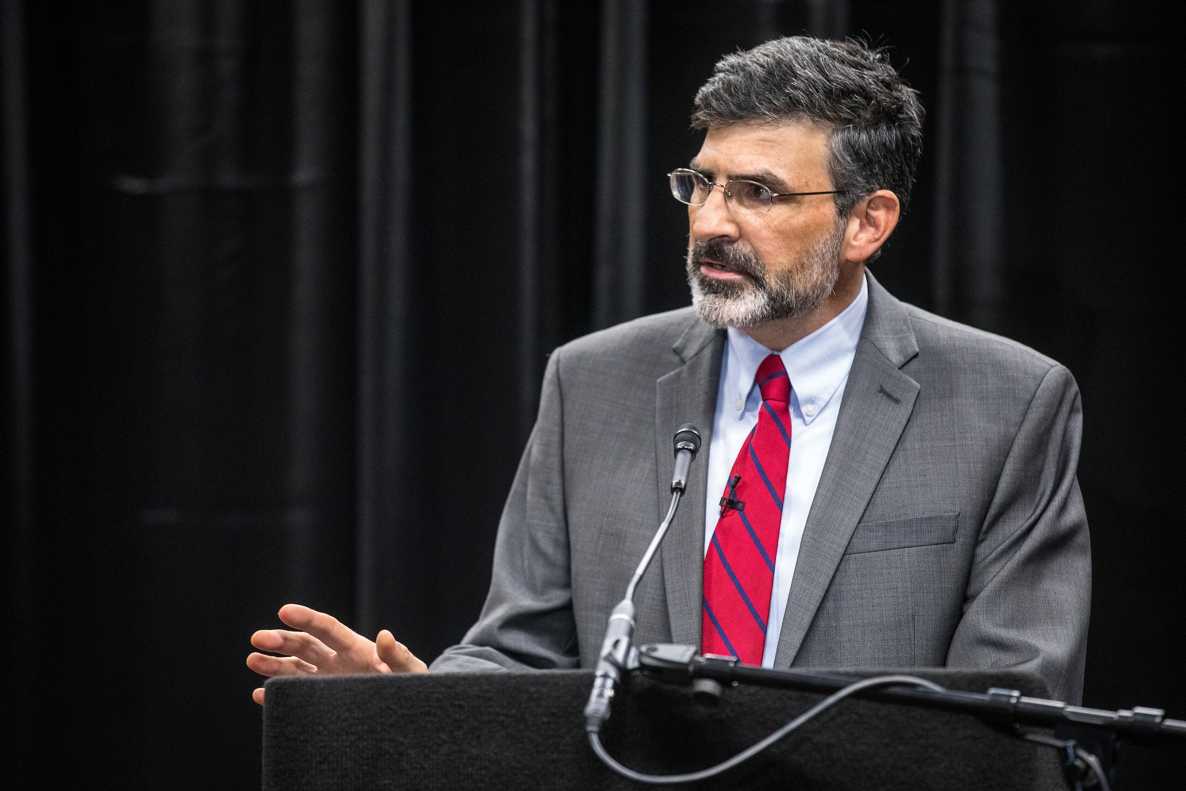 ASU Professor Paul Carrese speaks at a lectern onstage