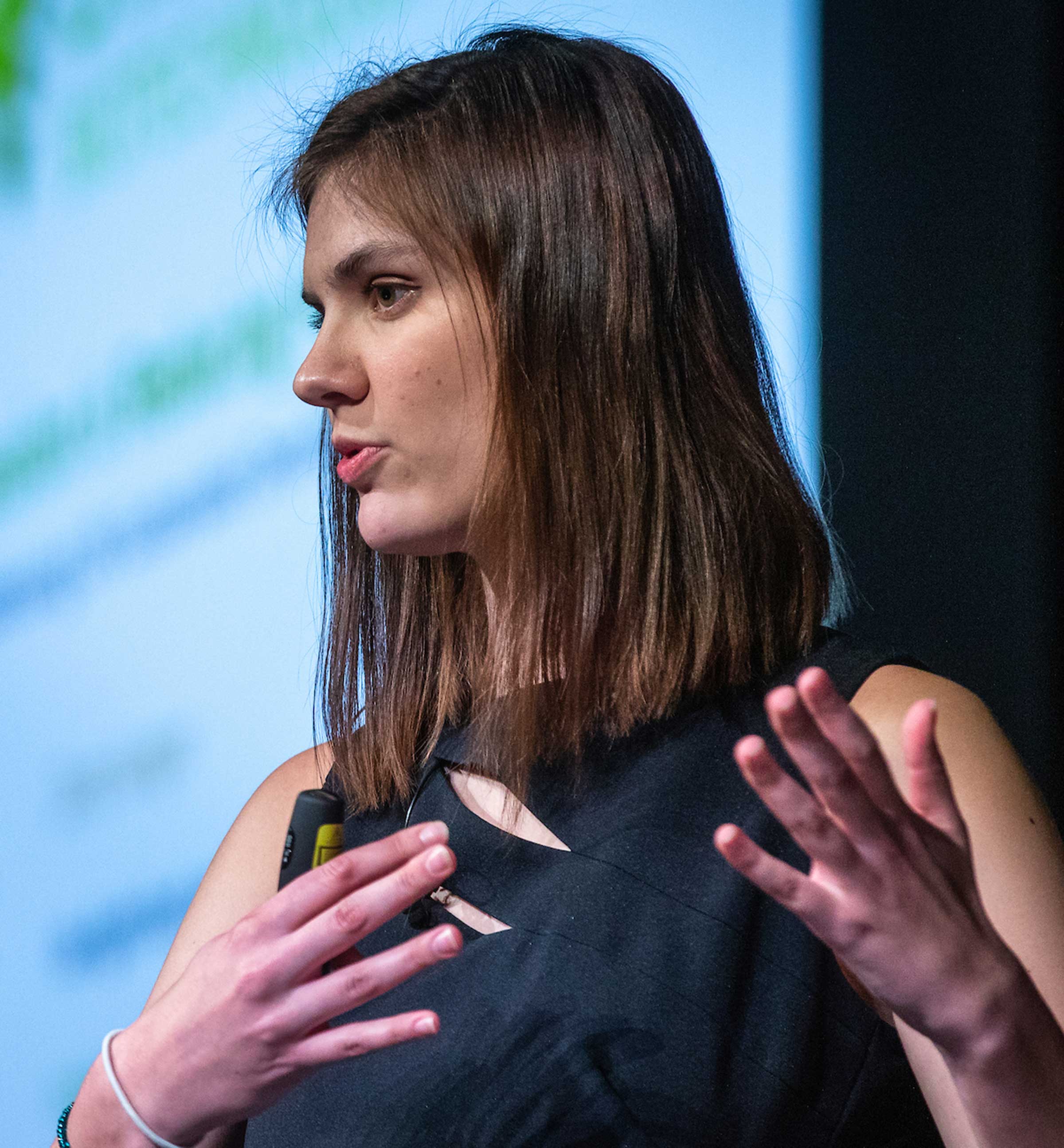 A woman speaks onstage