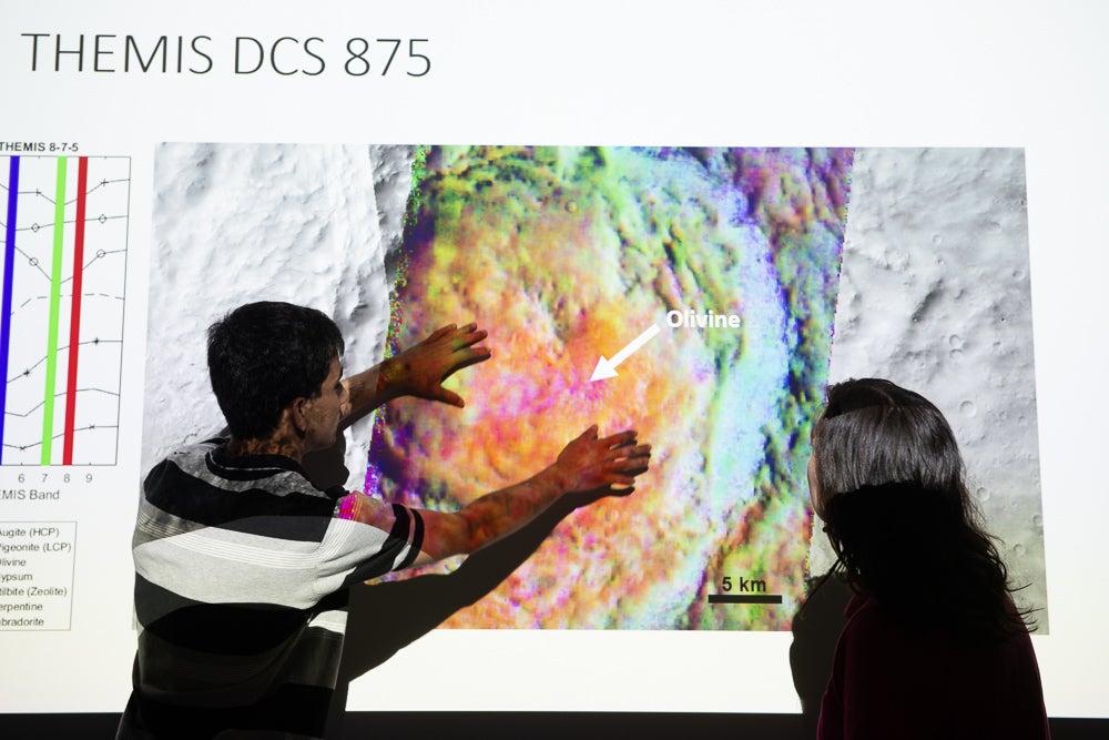 ASU student Aditya Khuller points to a map of Mars