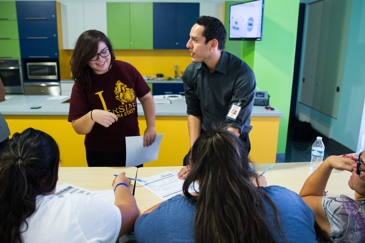  Tatiana Alvarado, 19, and St. Vincent De Paul Family Wellness Program Health Education Coordinator Ricardo Reyes speak to community members