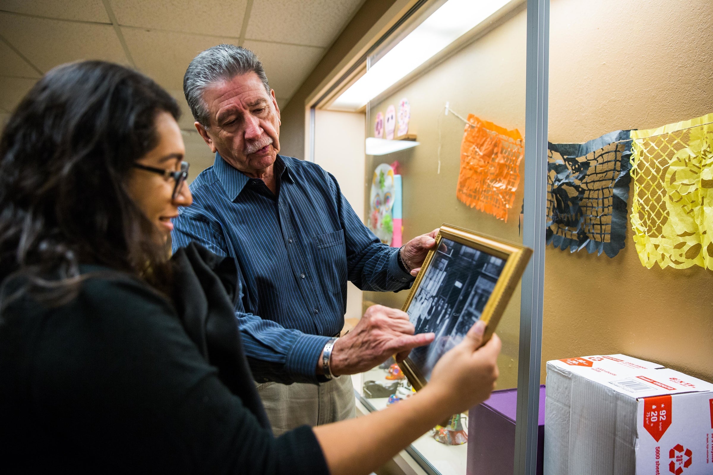 professor showing student photo of his family