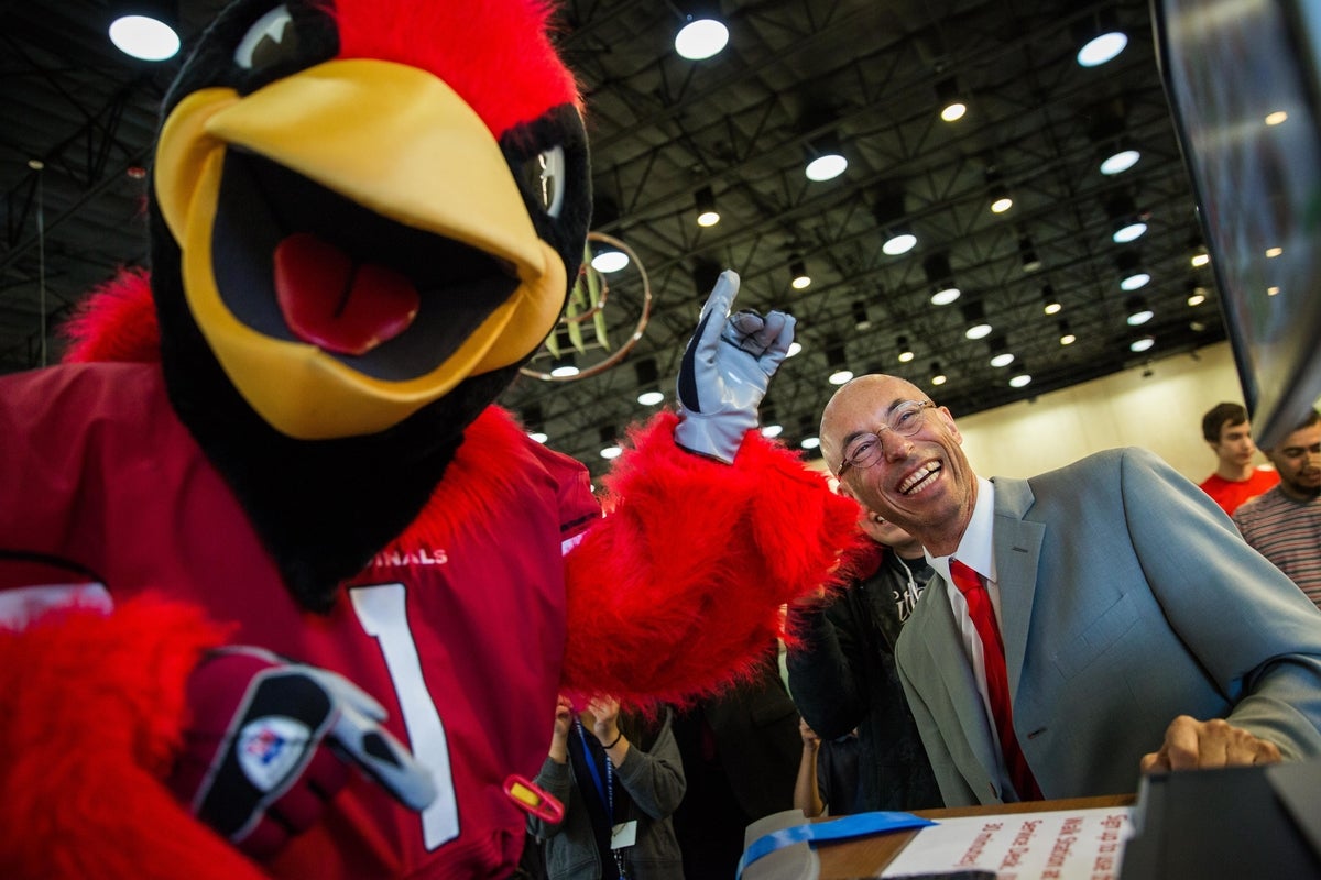 Bird mascot and well dressed man at a treadmill desk