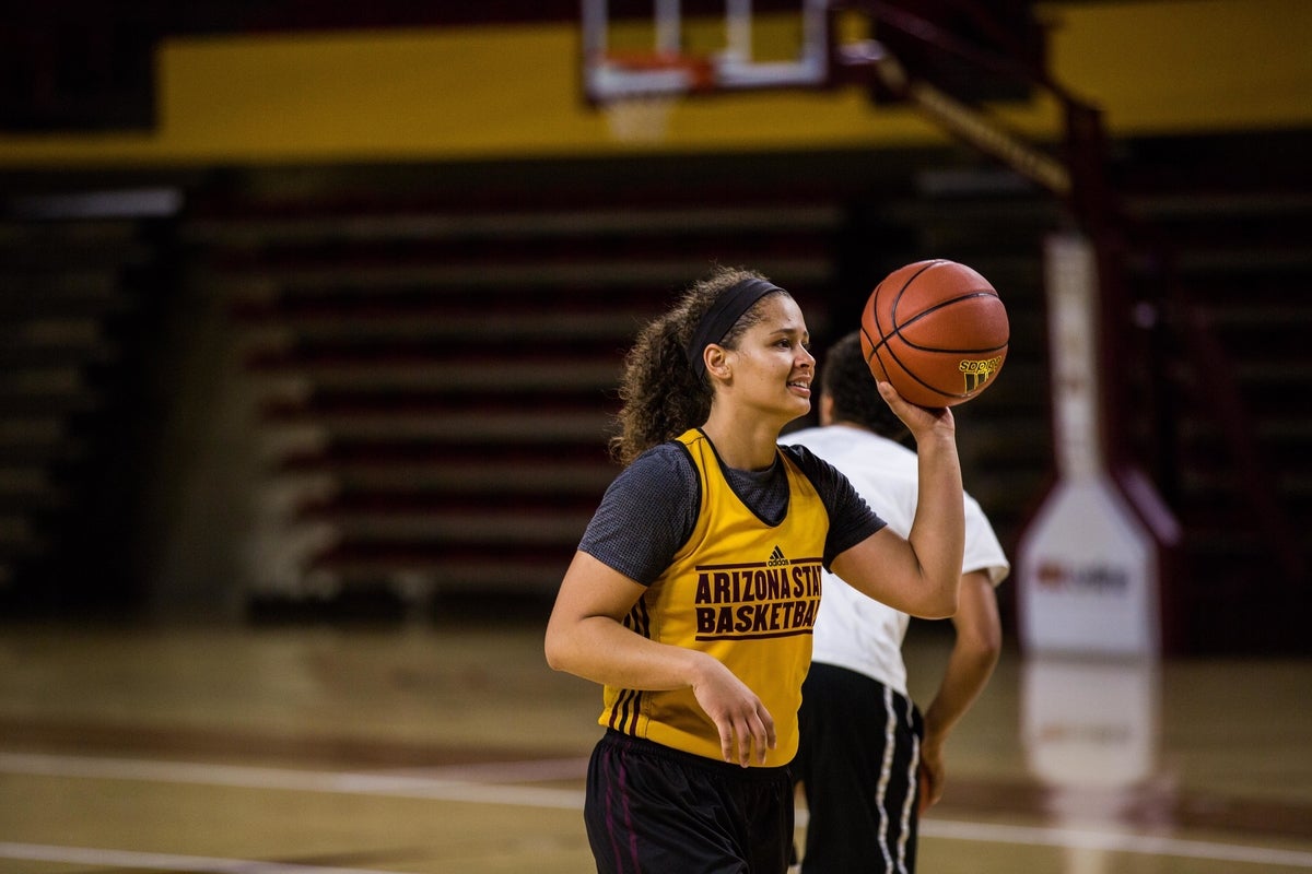 A woman playing basketball.