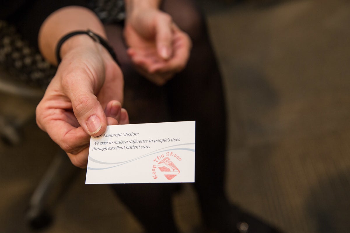 Hand holding a business card