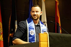 man speaking at ceremony