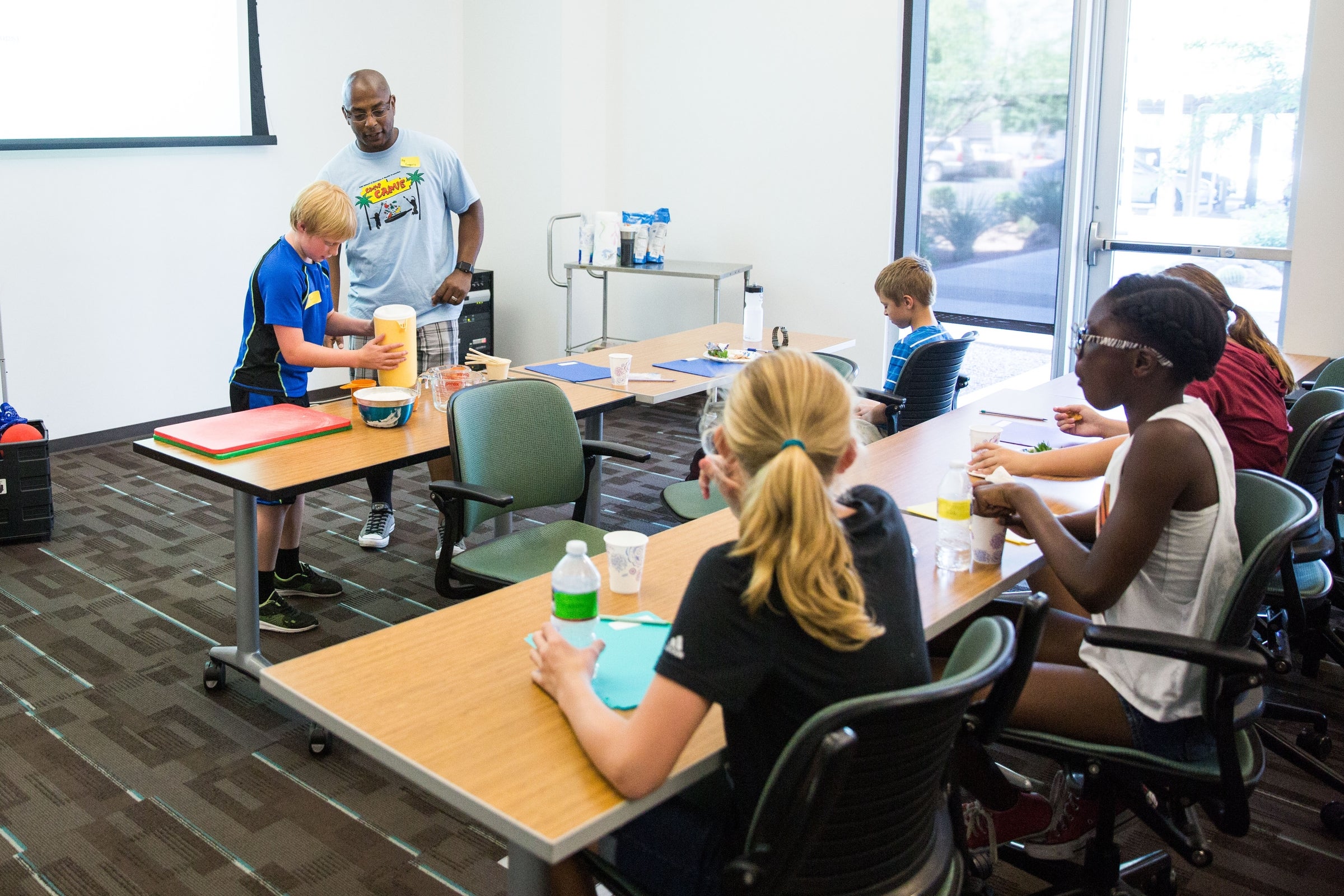 students learning how to measure at camp