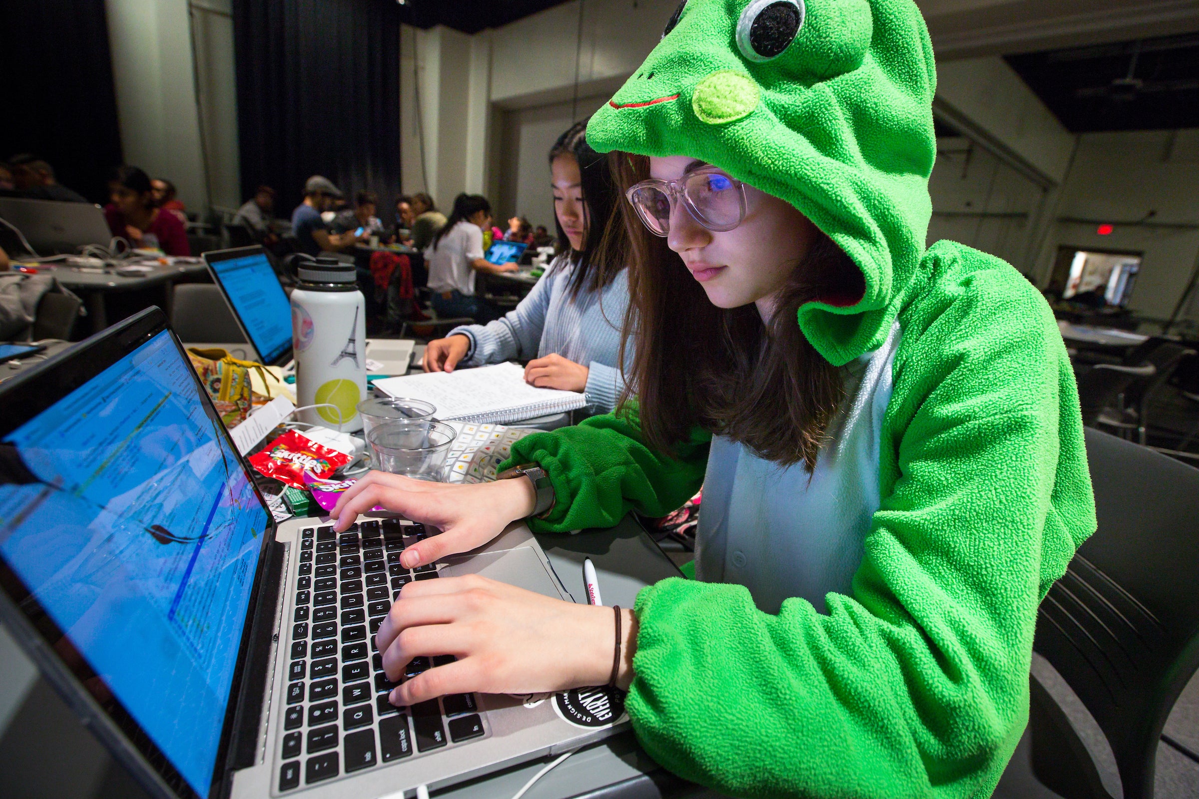 student working on laptop during hacking event