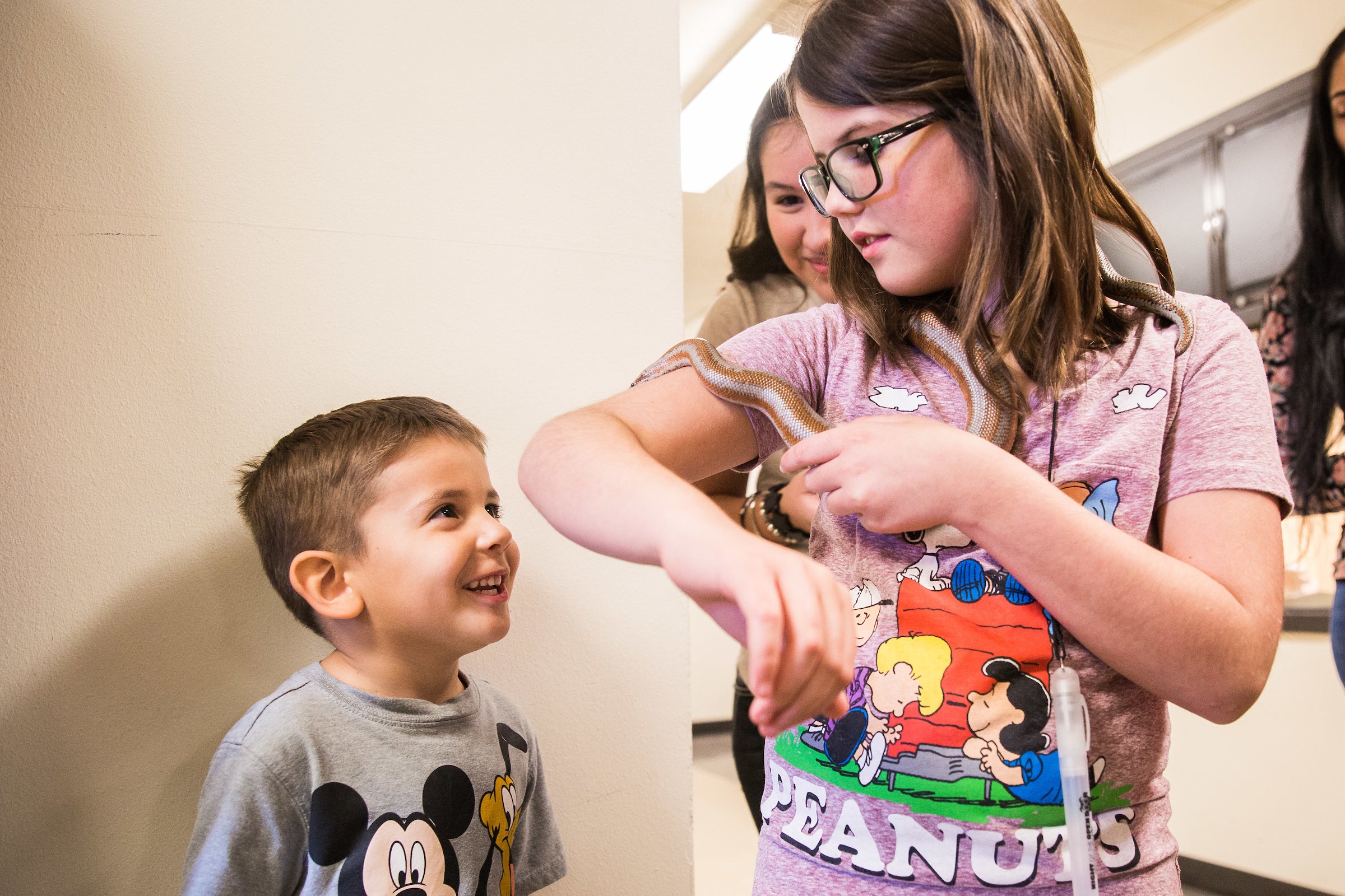 Children look at a snake