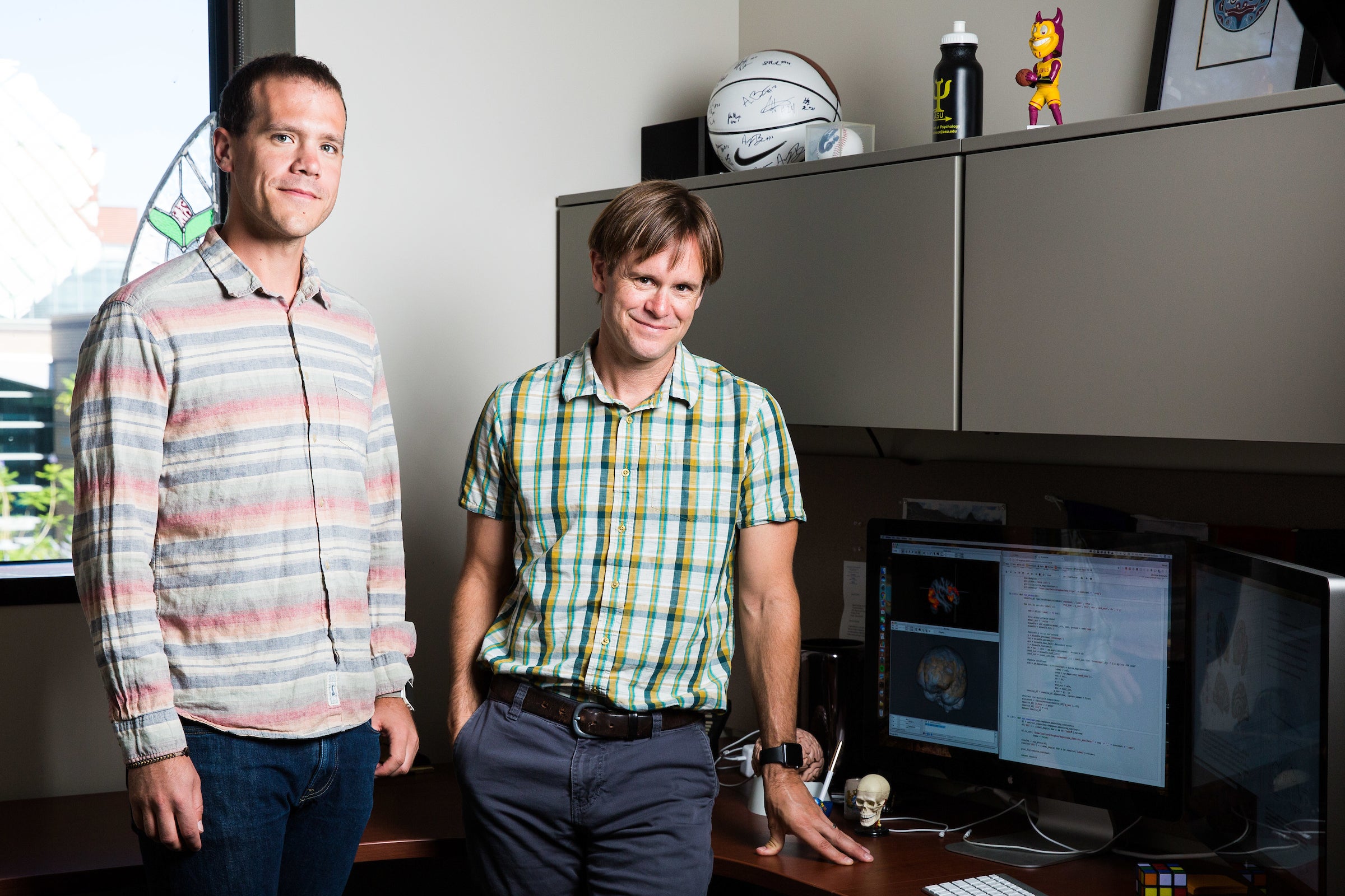 two men standing in office