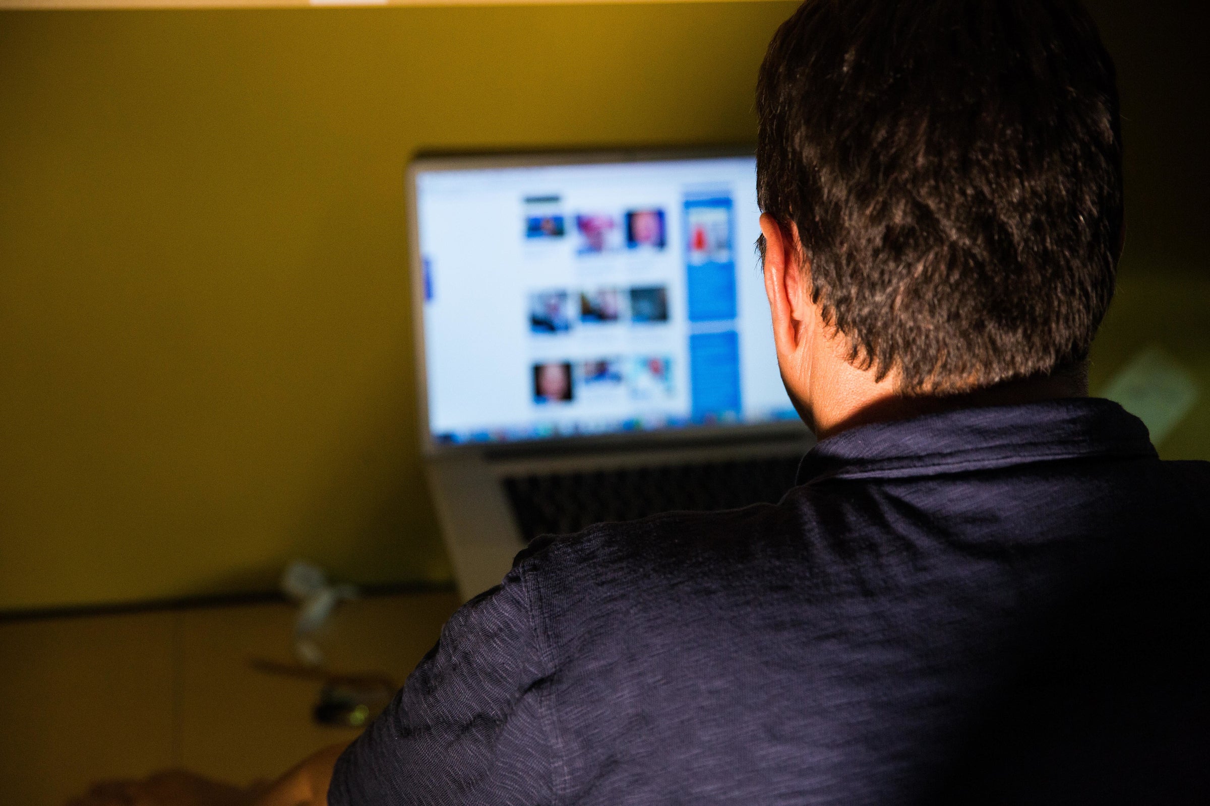 man looking at a website on a computer