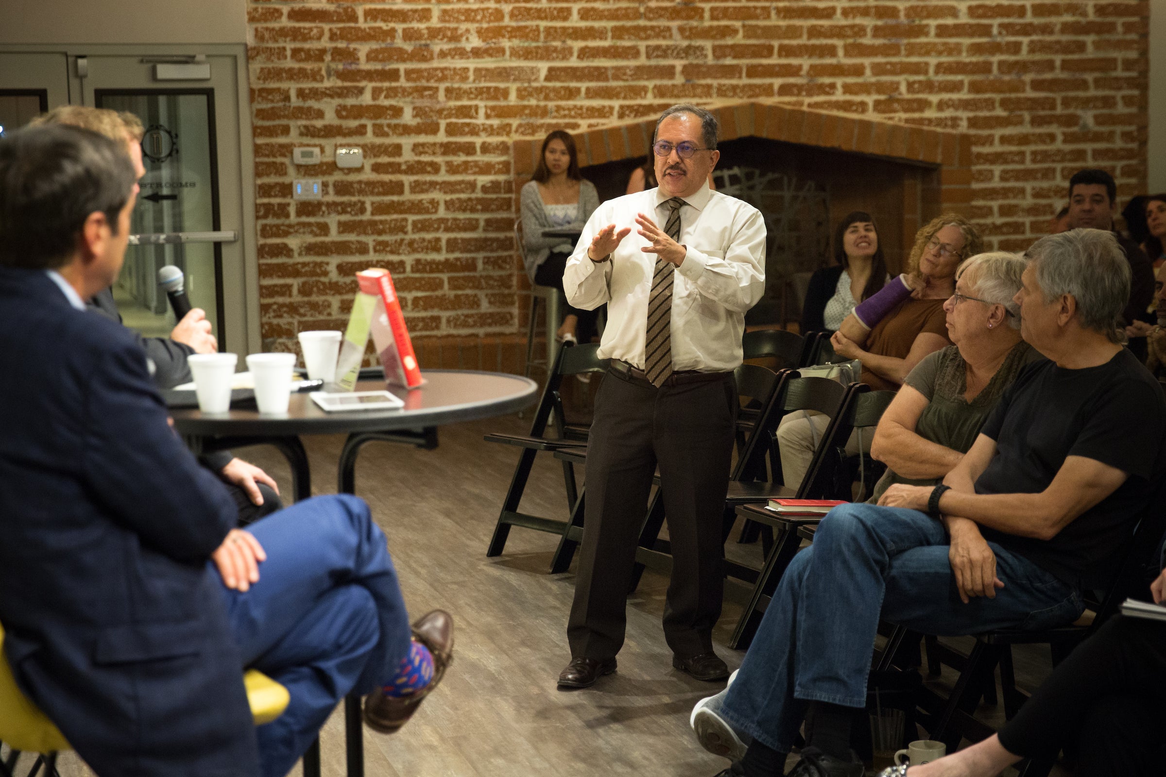 An attorney asks a question at a book signing