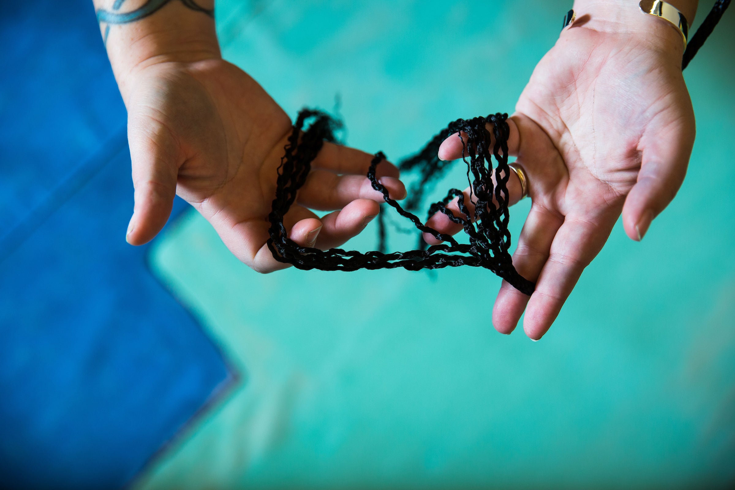 woman holding black cords