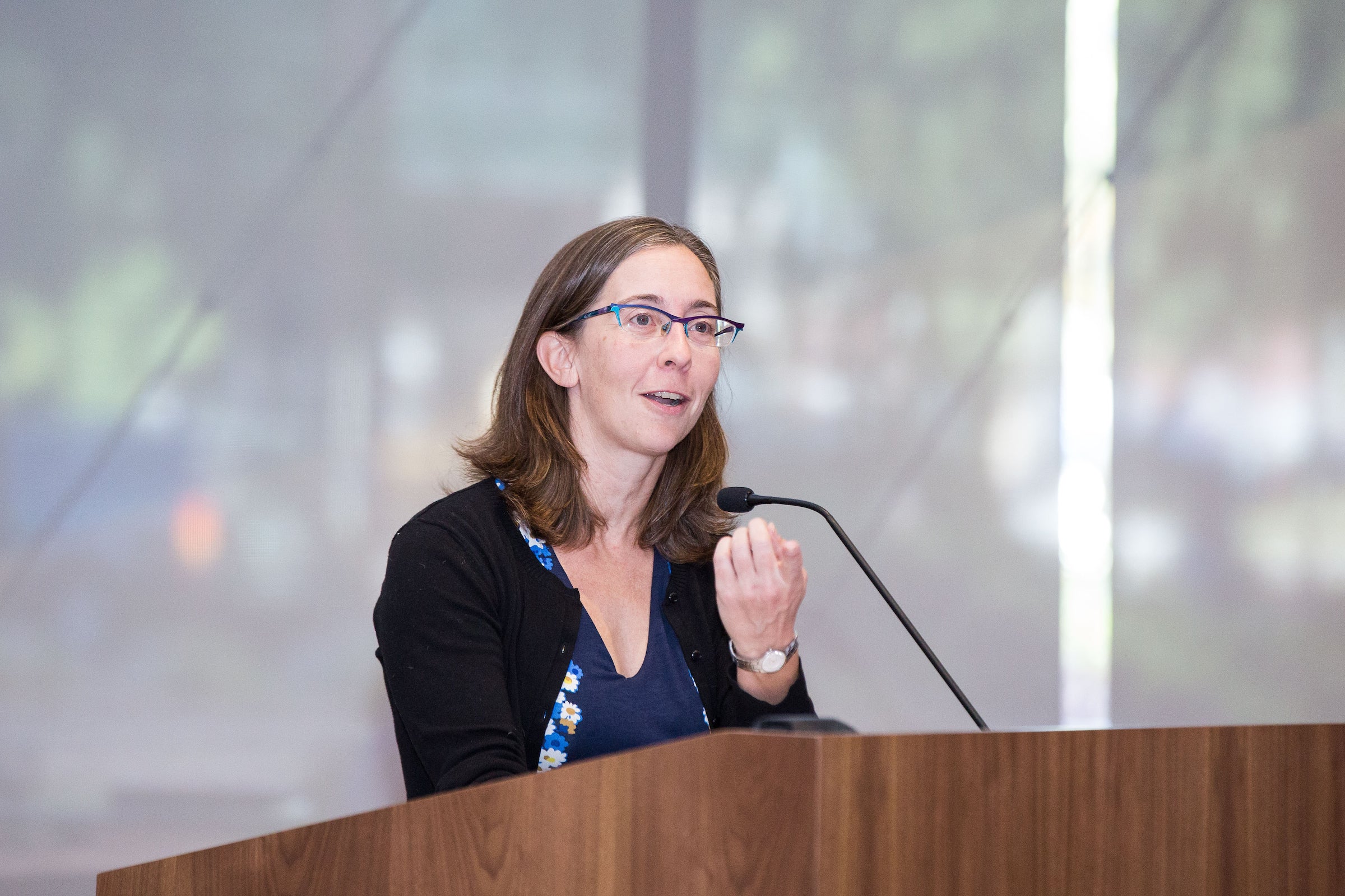 woman speaking at podium