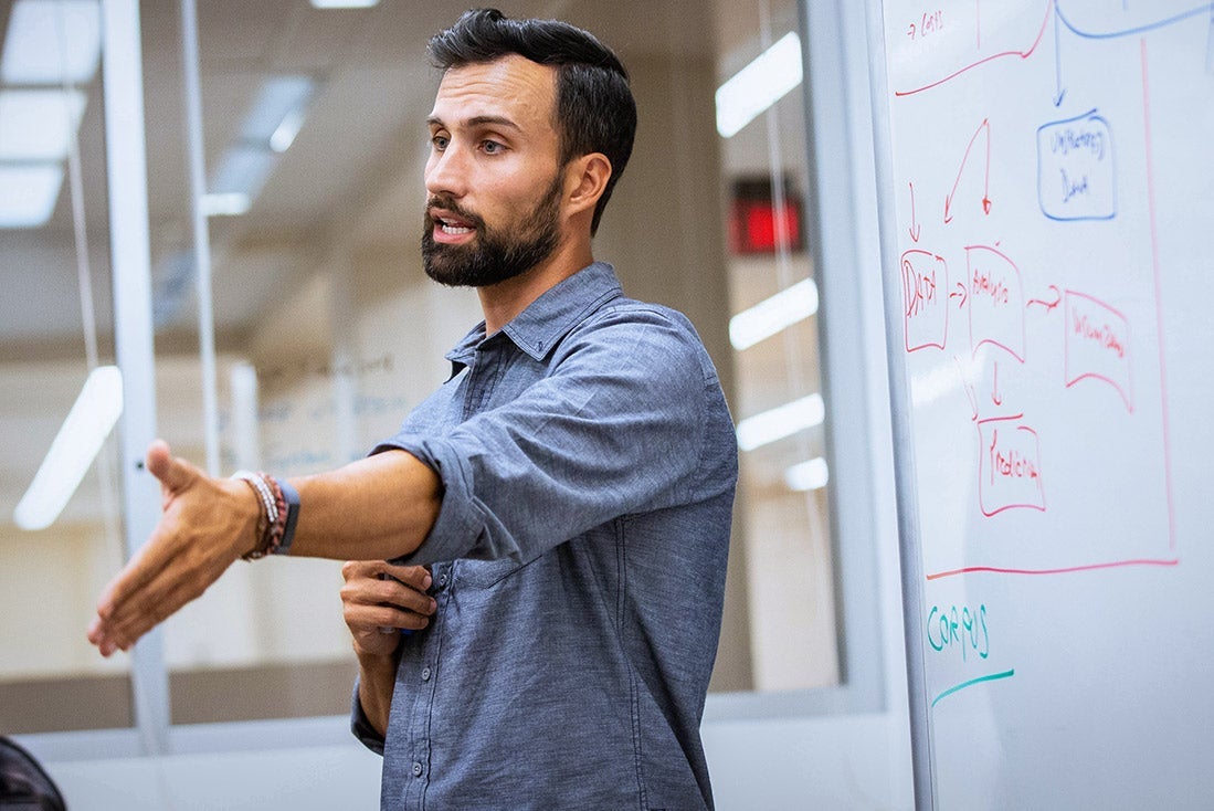 professor in front of white board