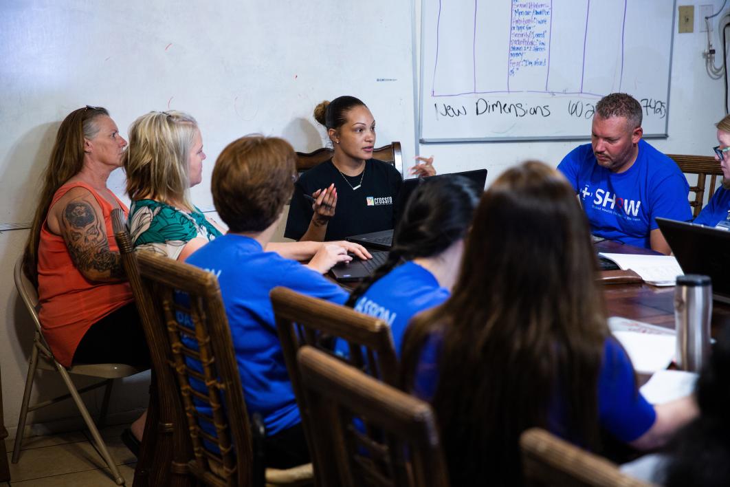 woman talking to a group at a table