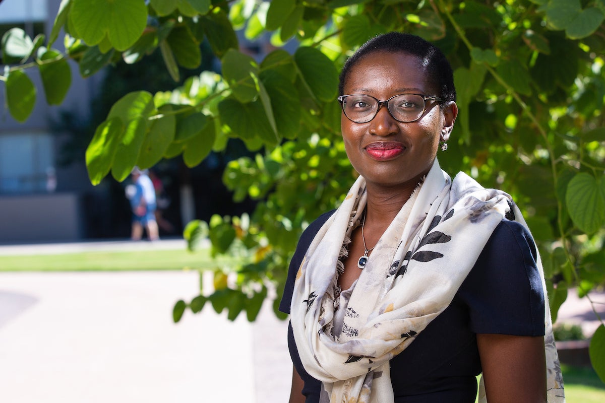 Woman in glasses and sweater smiling