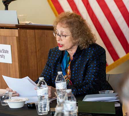 A professor reads a statement during a panel on climate change