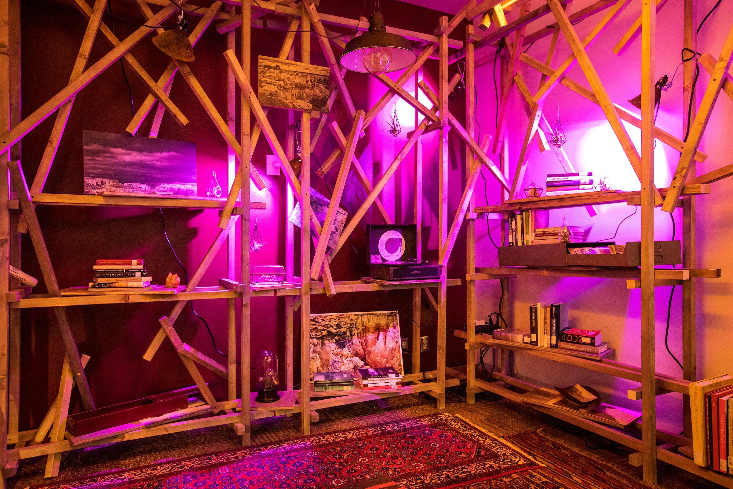 small room filled with books, maps, desert artifacts and a record player