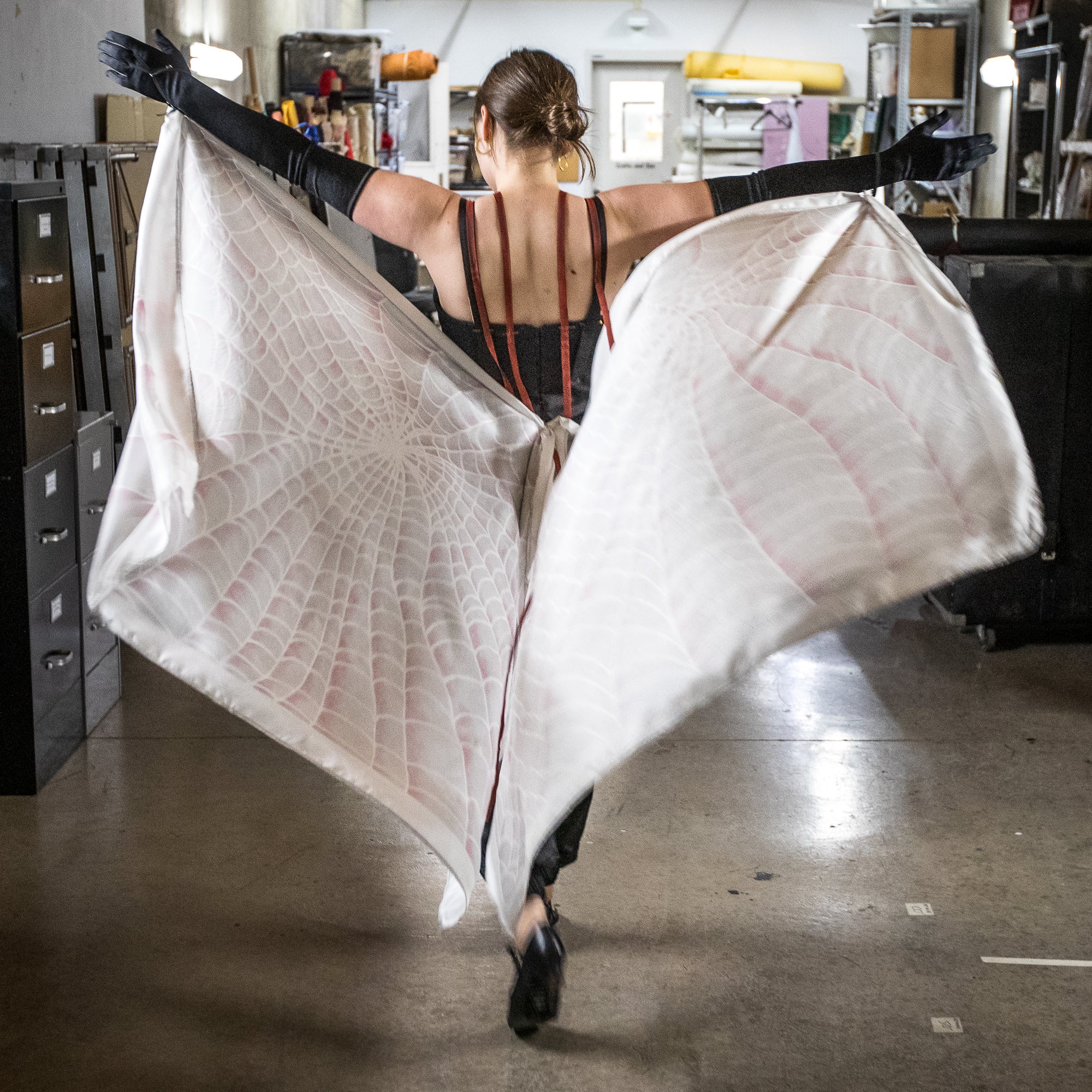 back of a woman wearing spider-themed costume