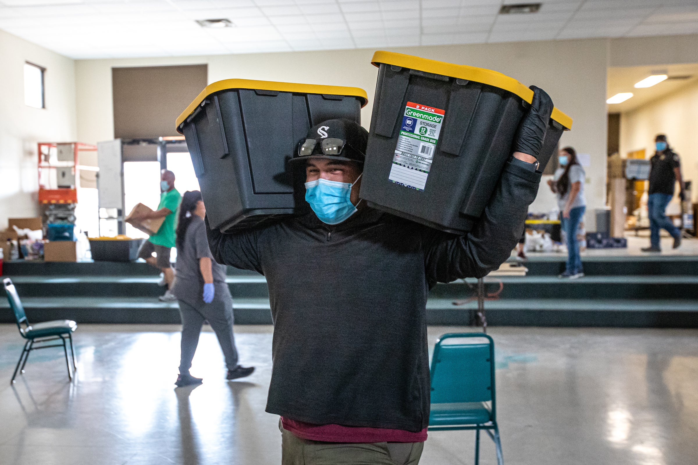 Volunteer carries donation bins