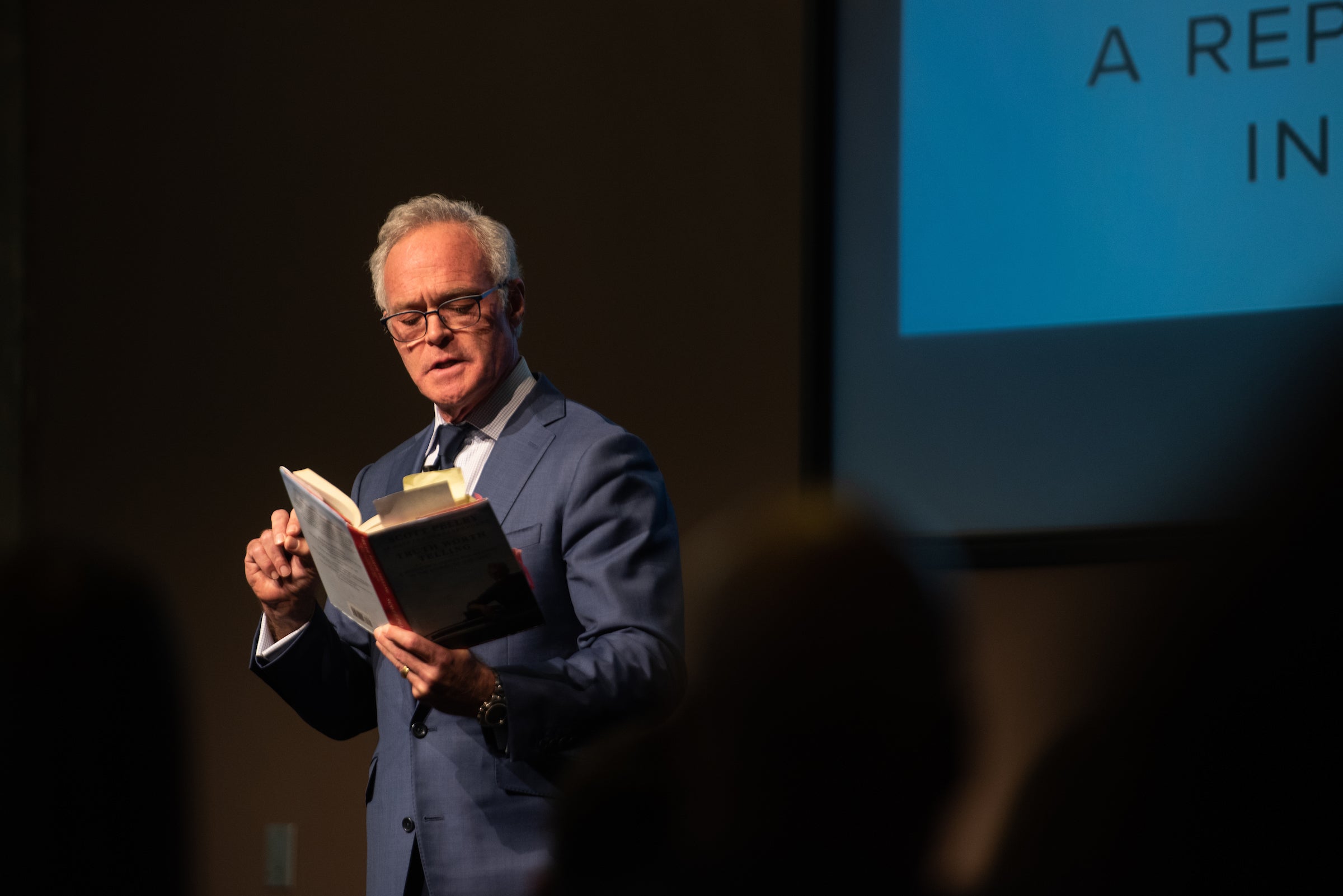 man reading from book