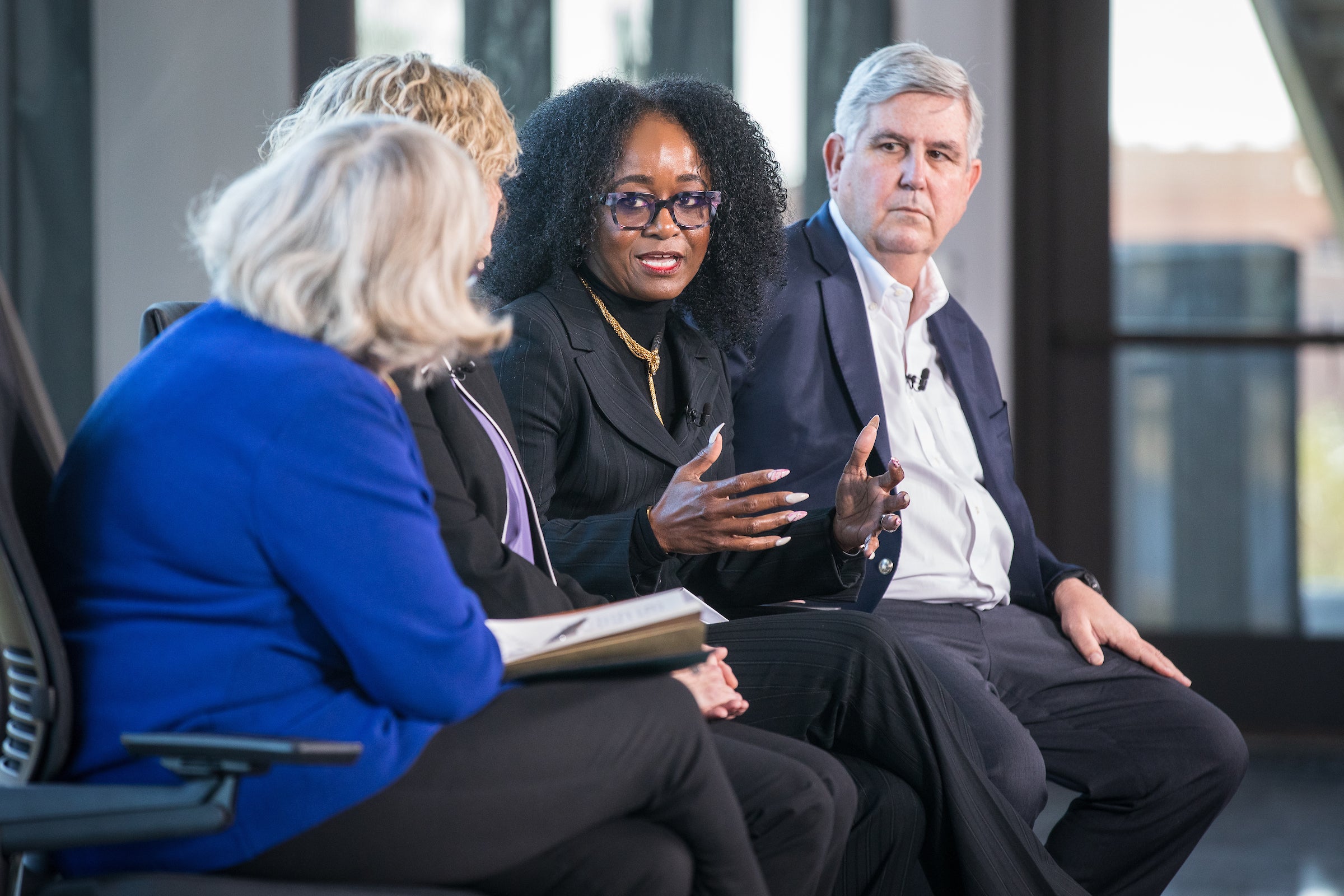 Panelists sit onstage