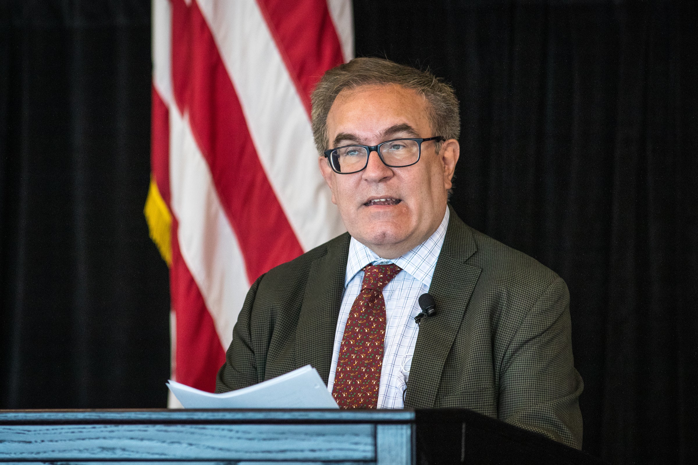 man speaking at lectern