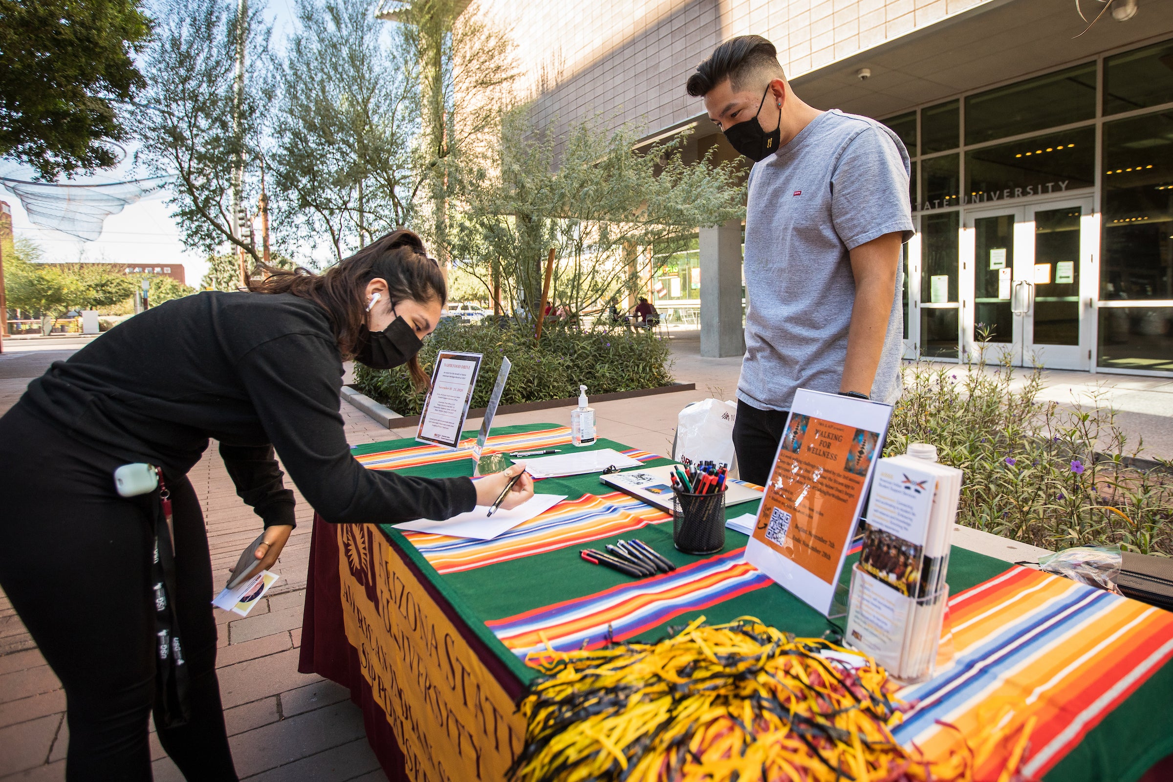 student signing up at table