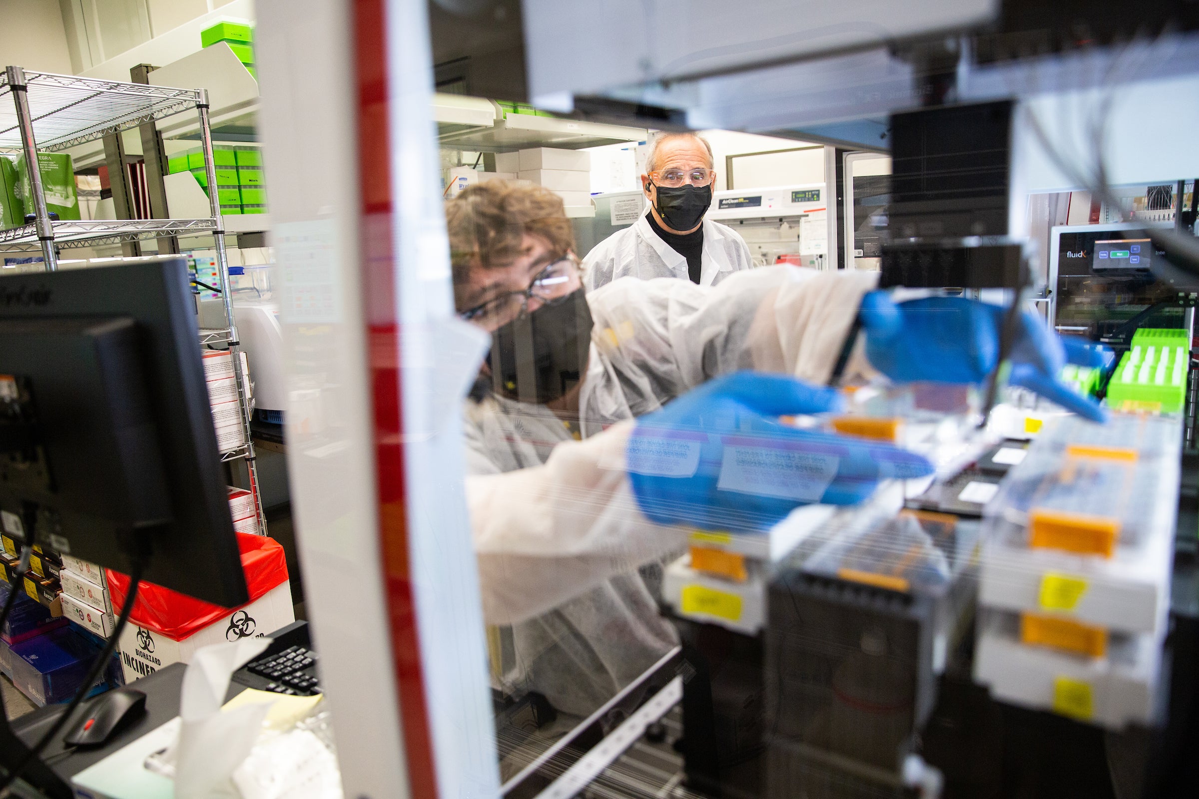 Two researchers working in COVID saliva lab