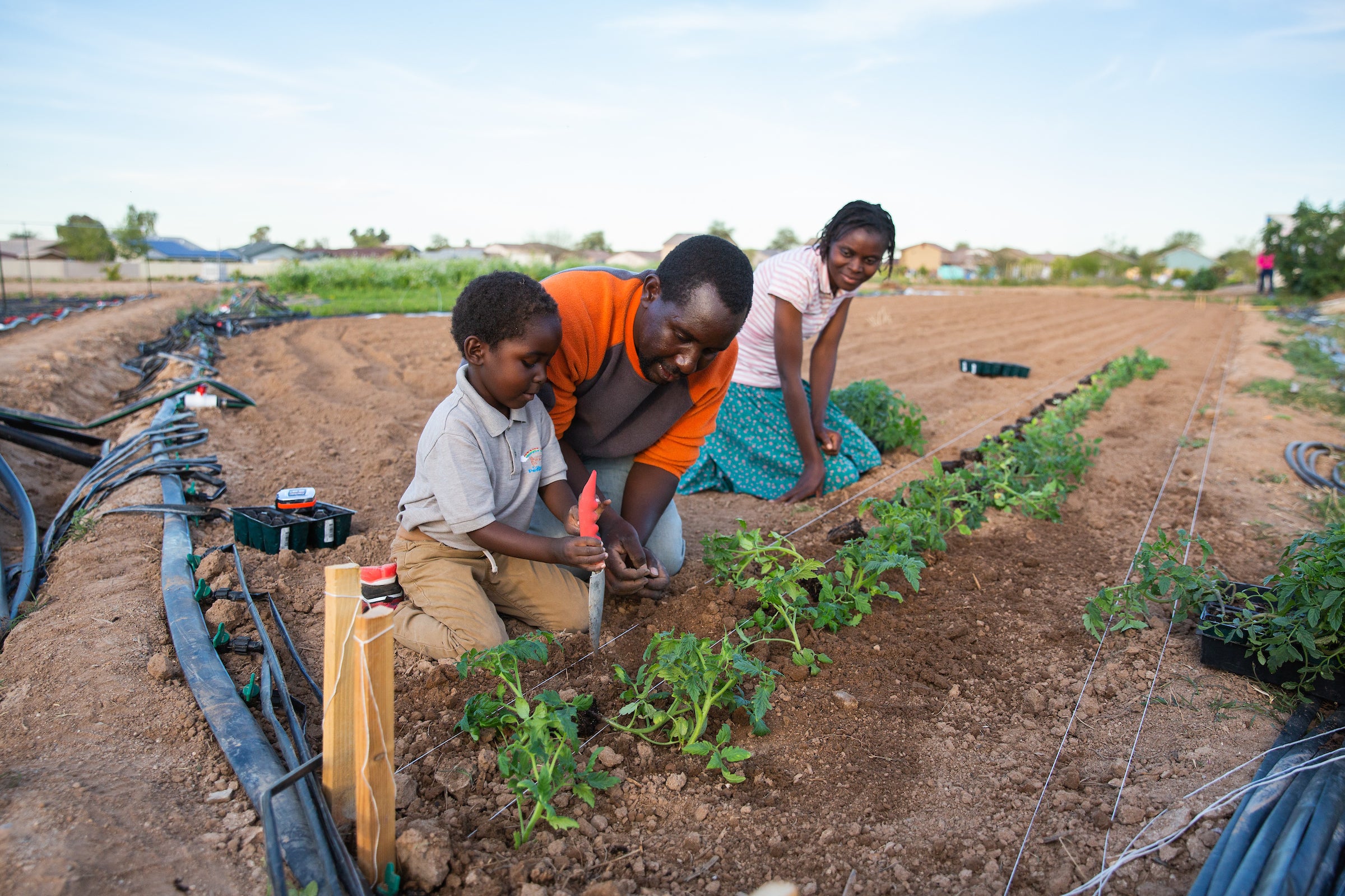 family planting in community garden