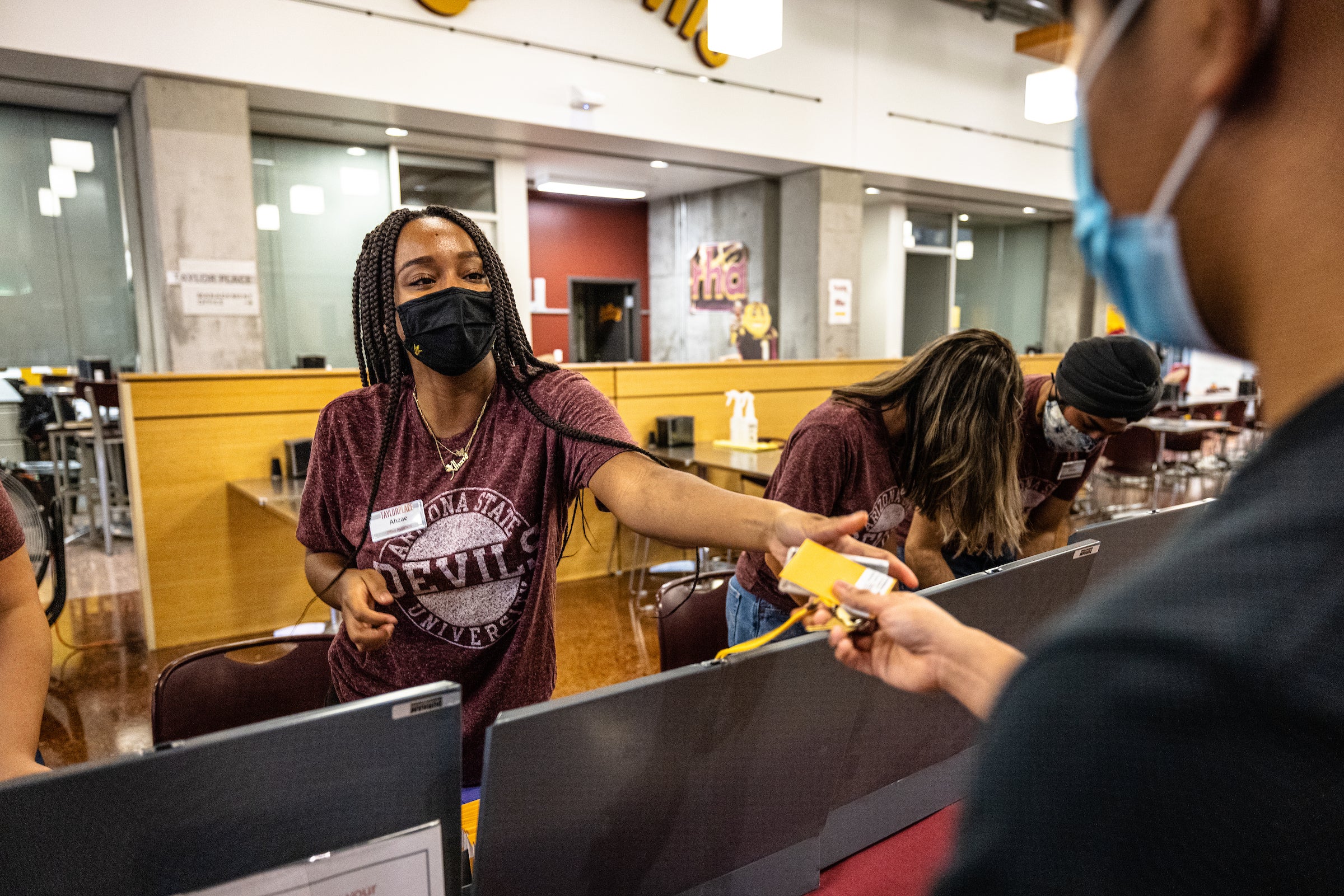 woman handing keys to student