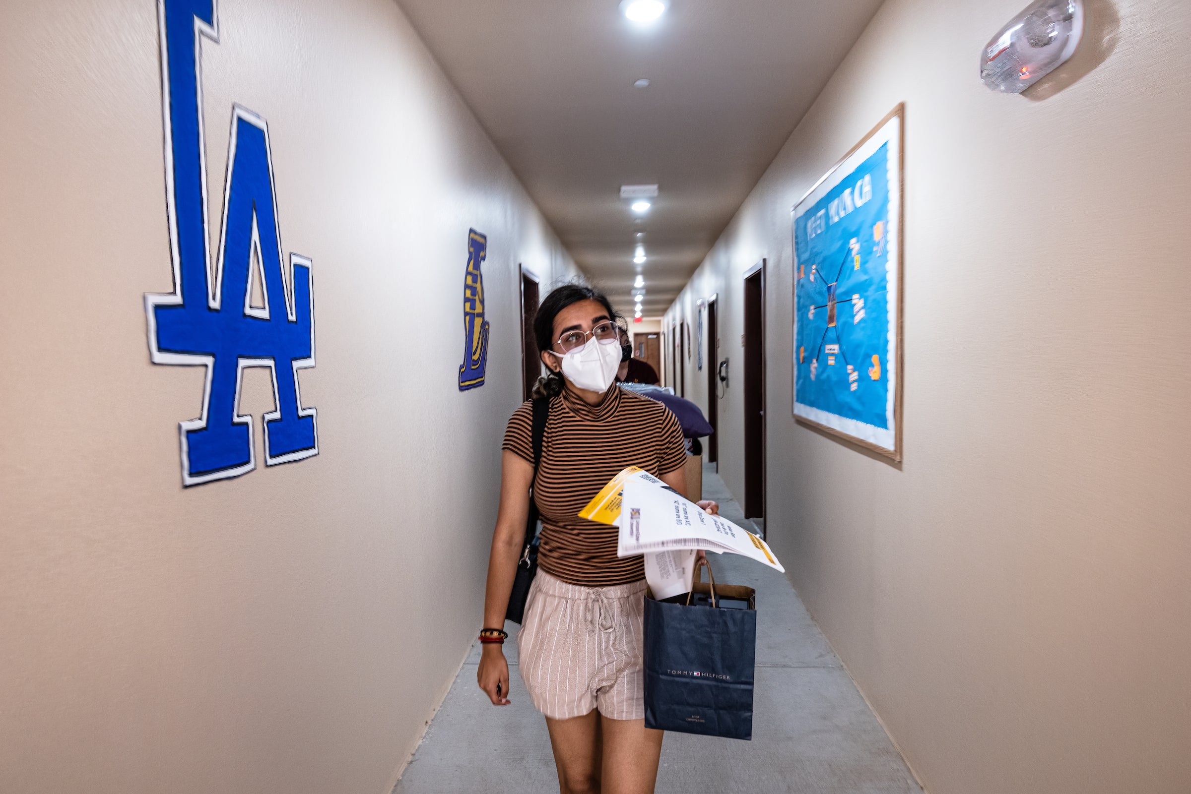 student walking down residential facility hall