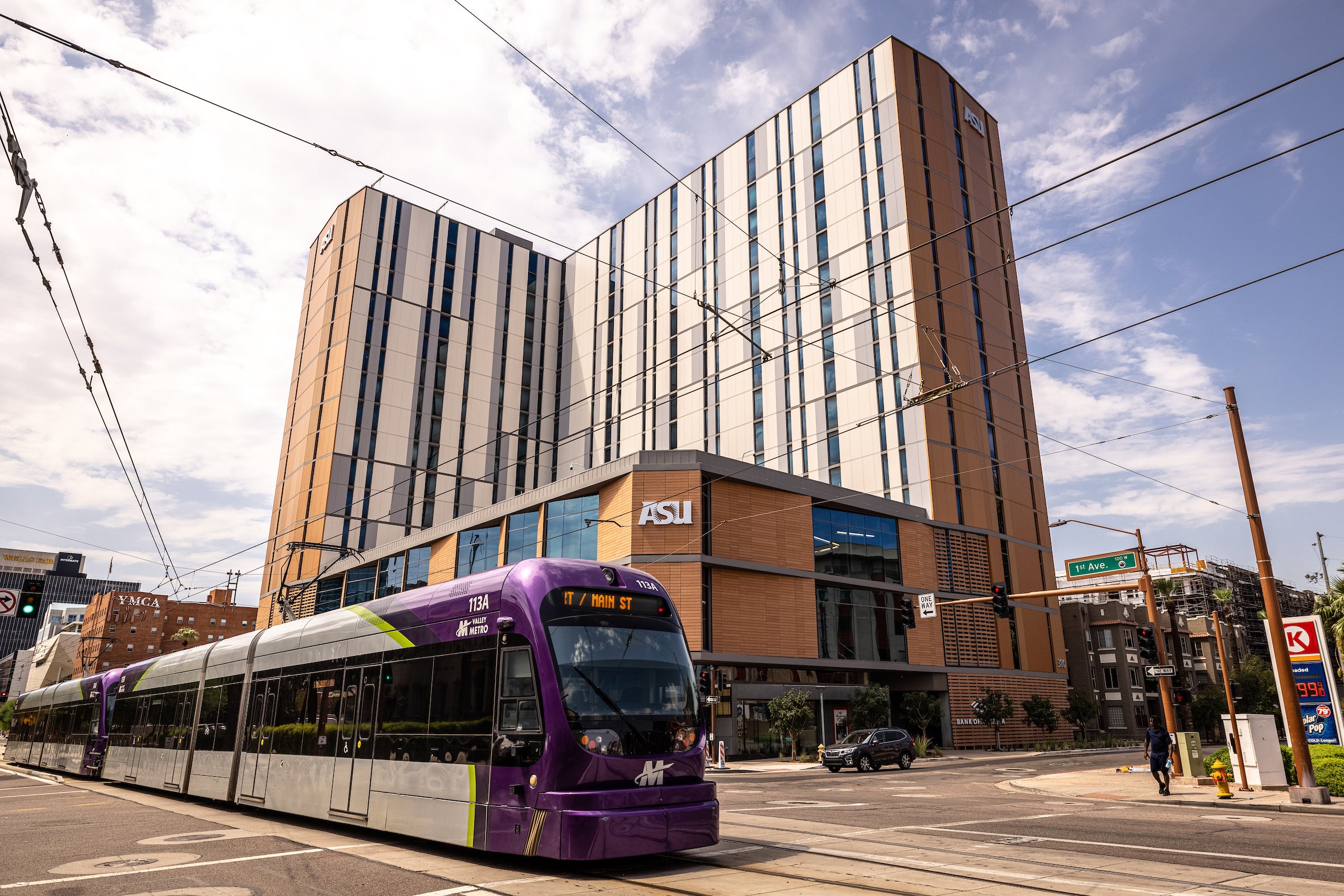 downtown Phoenix building with light rail crossing in front of it