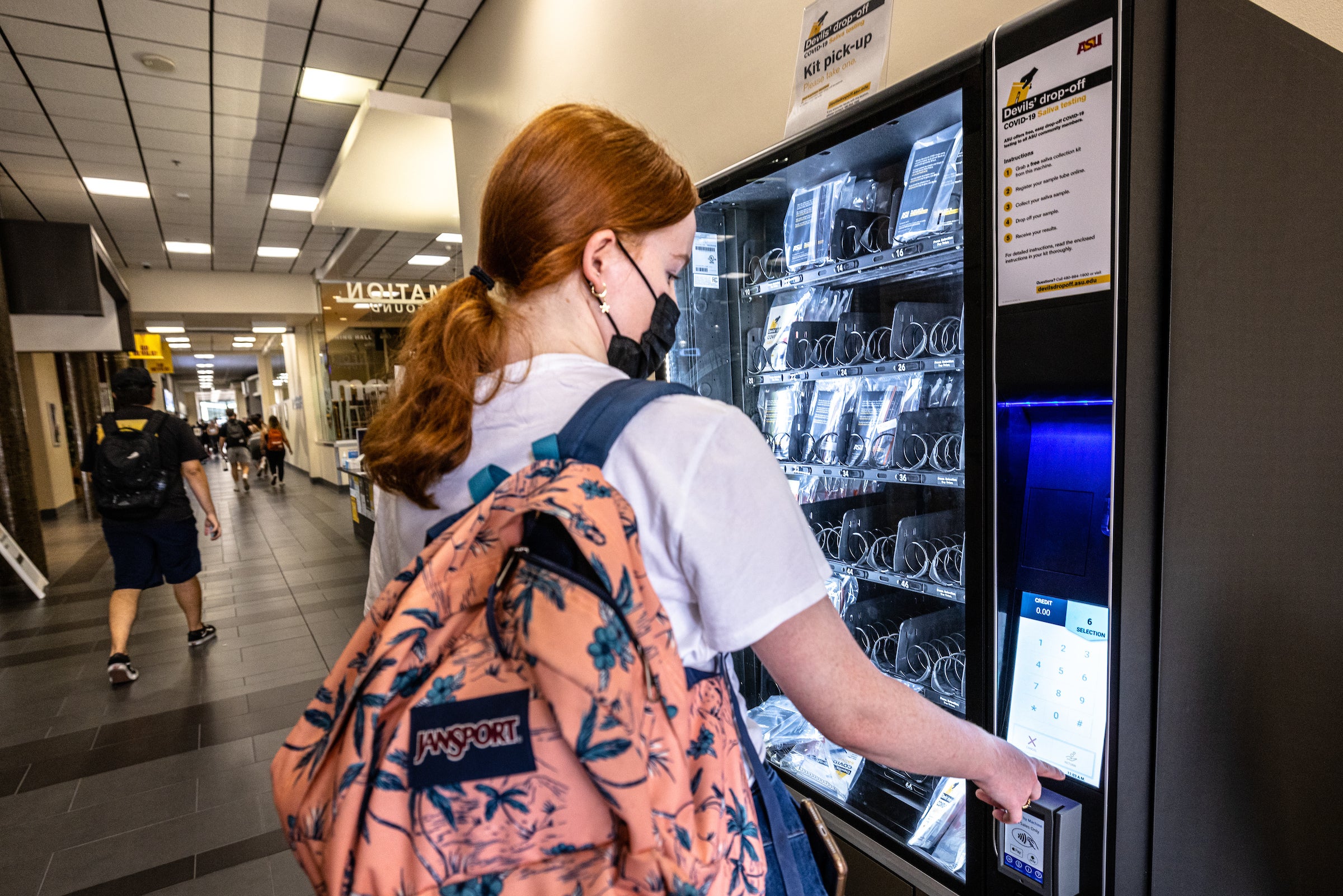 woman works a vending machine