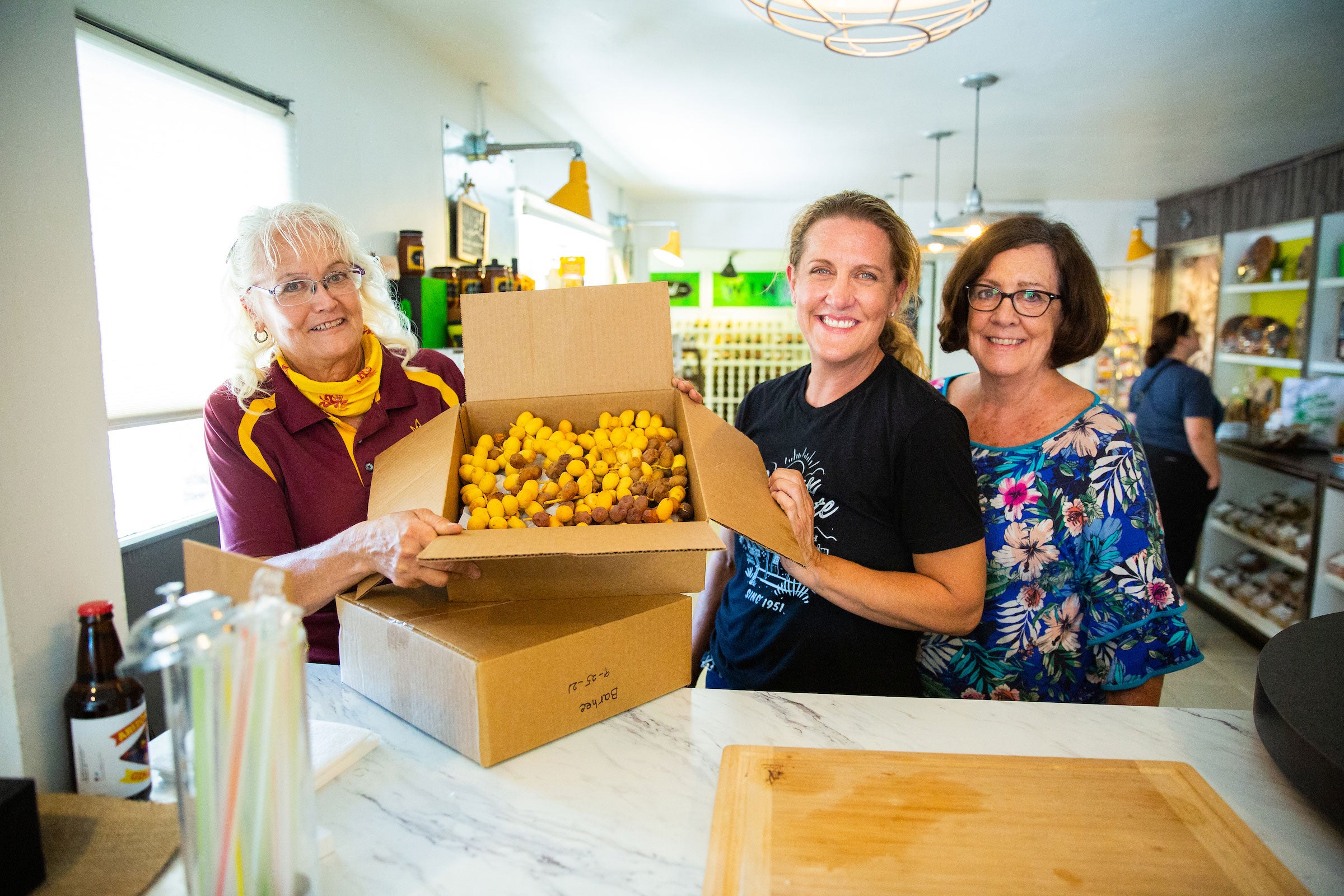 women holding box of dates