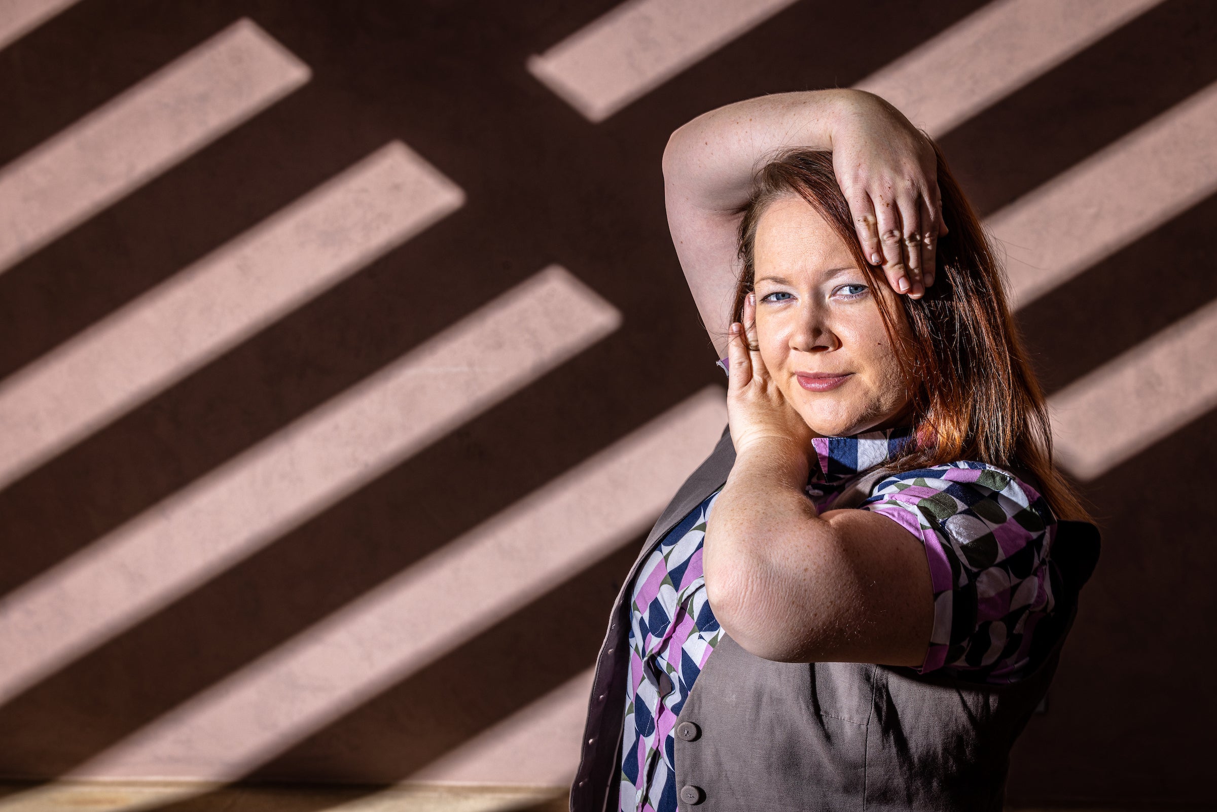 woman posing outside of fine arts center building