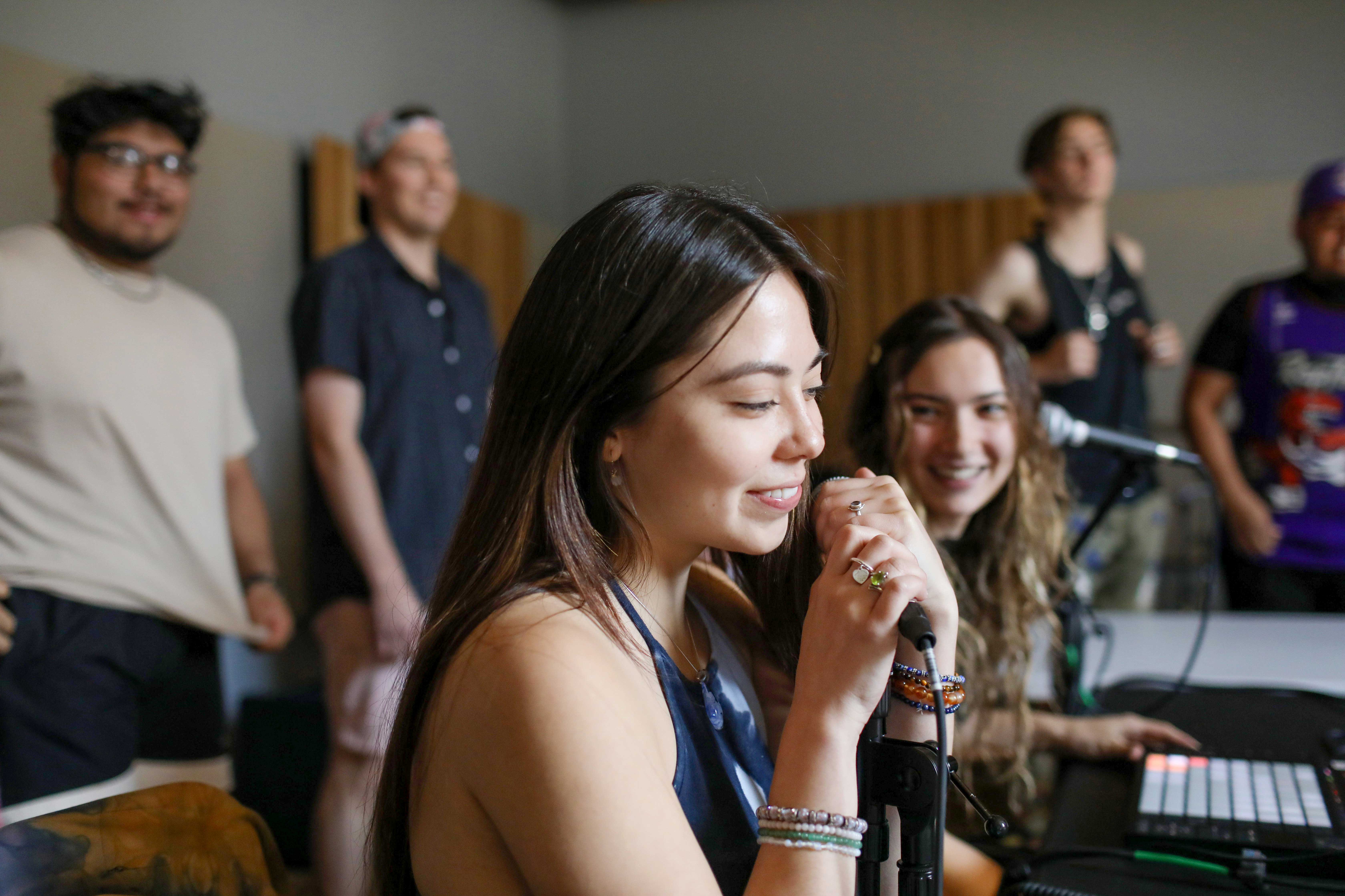 Woman singing into microphone